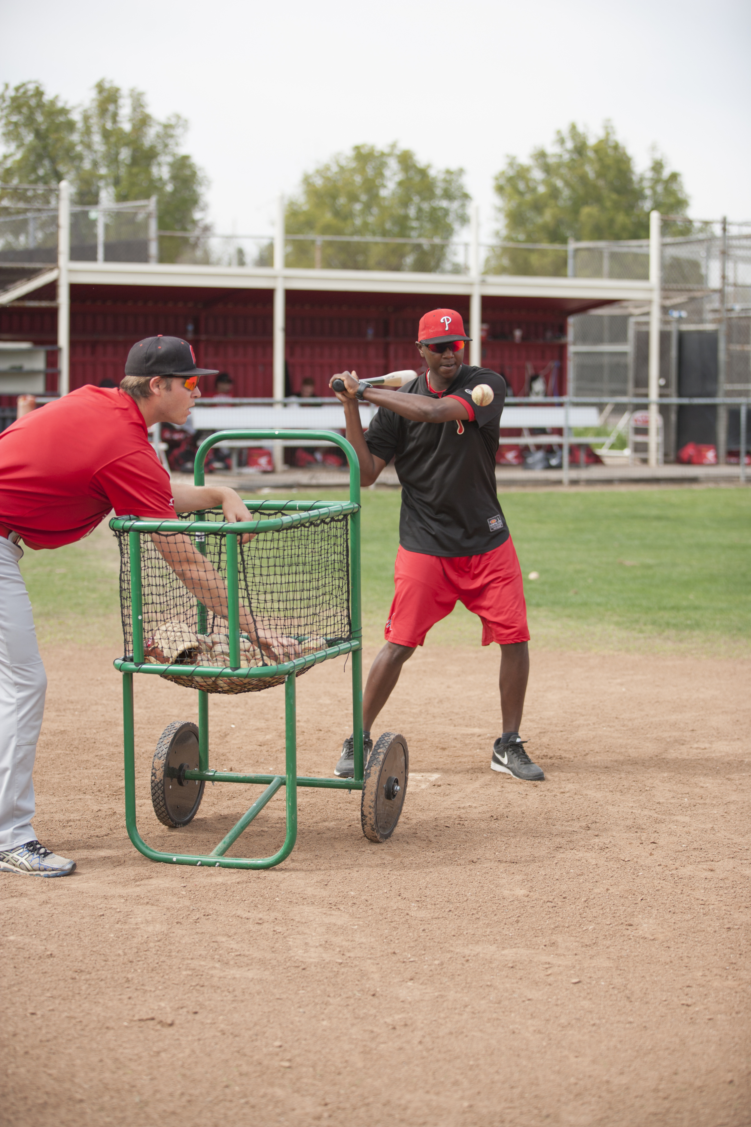  Devin Joblove and assistant coach Tyrus Powe hit balls for infielders to catch during a fielding drill on Tuesday, March 10, 2015. Woodland Hills, Calif.  Read the full story&nbsp; here  