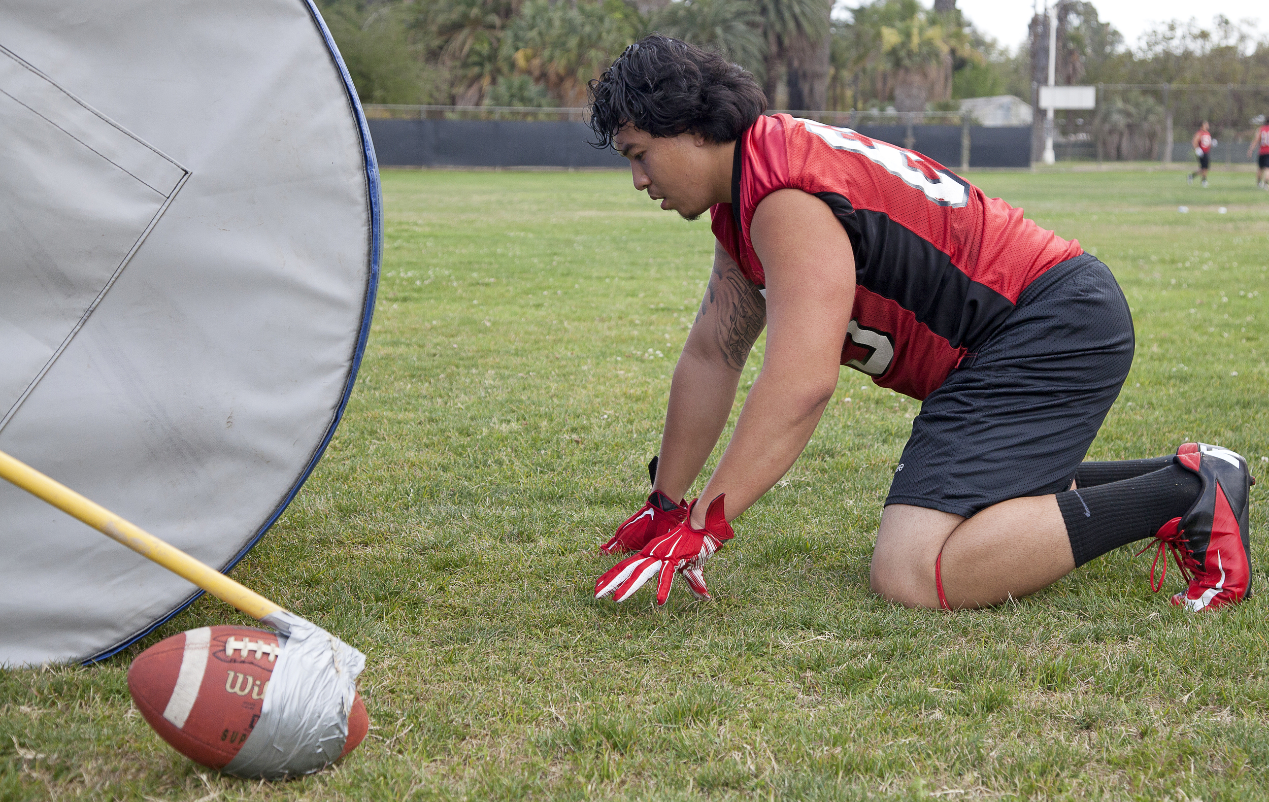  Defensive tackle Joe Achour readies to push a weighted cylinder during spring practice and training on Thursday, May 21, 2015. Pushing the cylinder is meant to help players push opposing players during a game. Woodland Hills, Calif.&nbsp; 