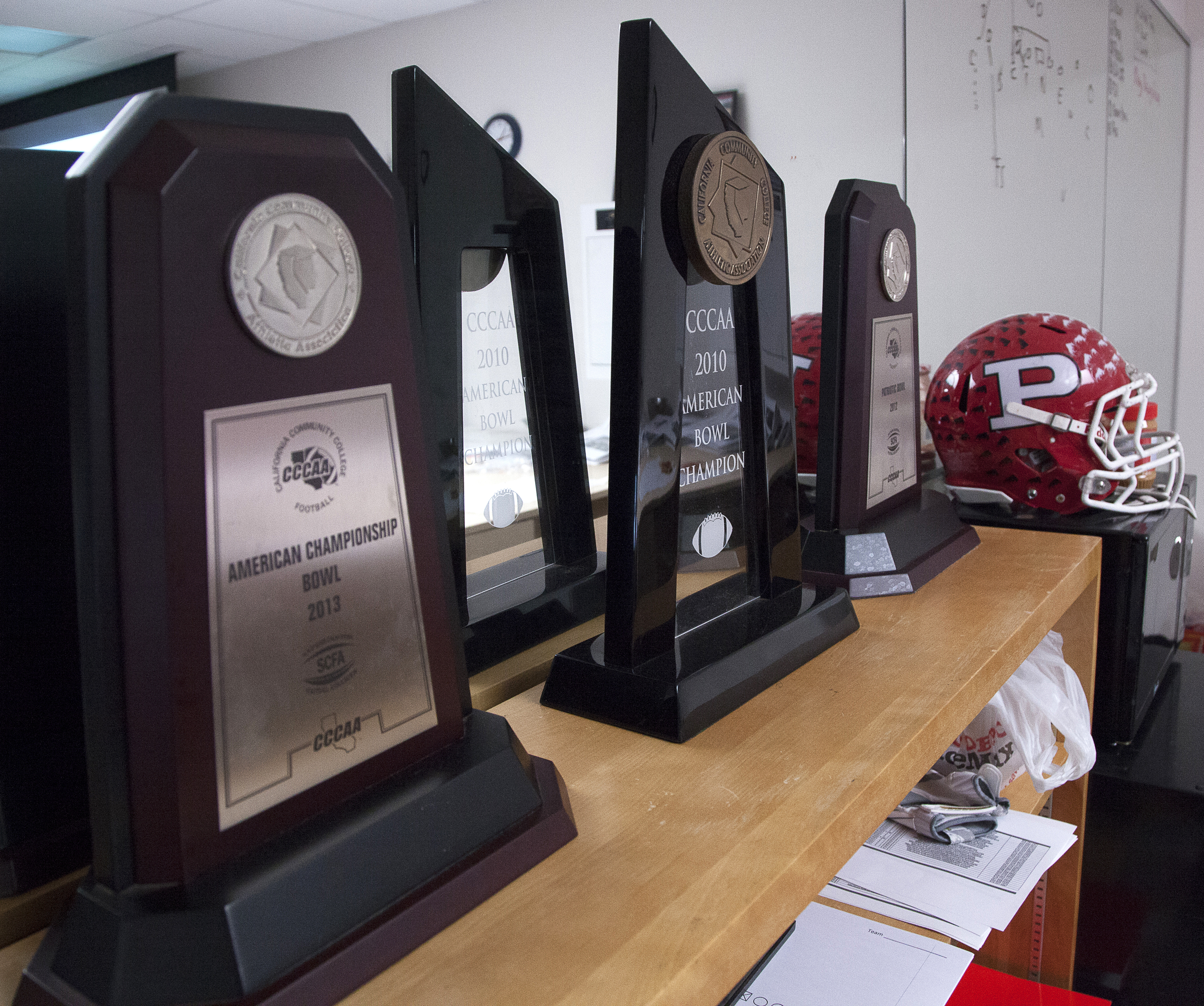  Trophies from past seasons line the top of a bookcase inside the “war room” where the football defensive team meet. Thursday, May 21, 2015. Woodland Hills, Calif.&nbsp;    