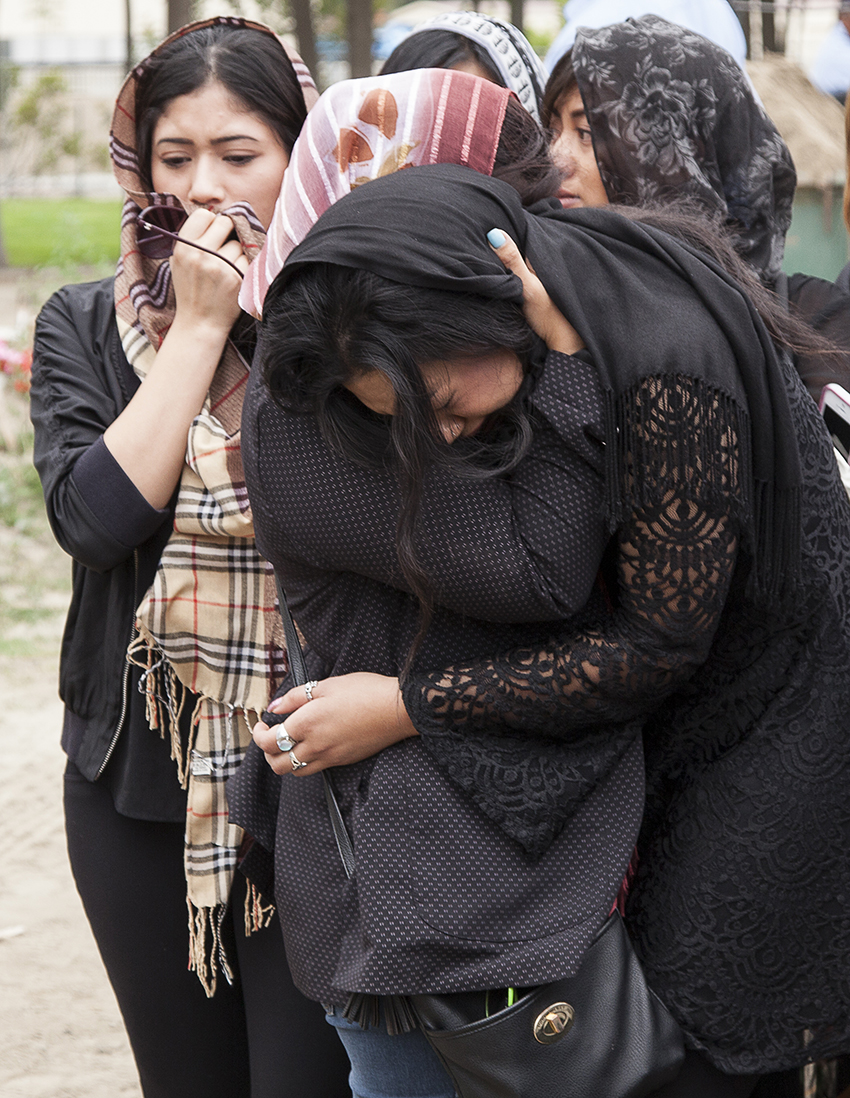  Daughter of Djauhari Abdoussalaam, Myra Djauhari, is seen being comforted as she mourns during her father's funeral in Garden Grove, Calif. on&nbsp;Saturday, June 27, 2015. 