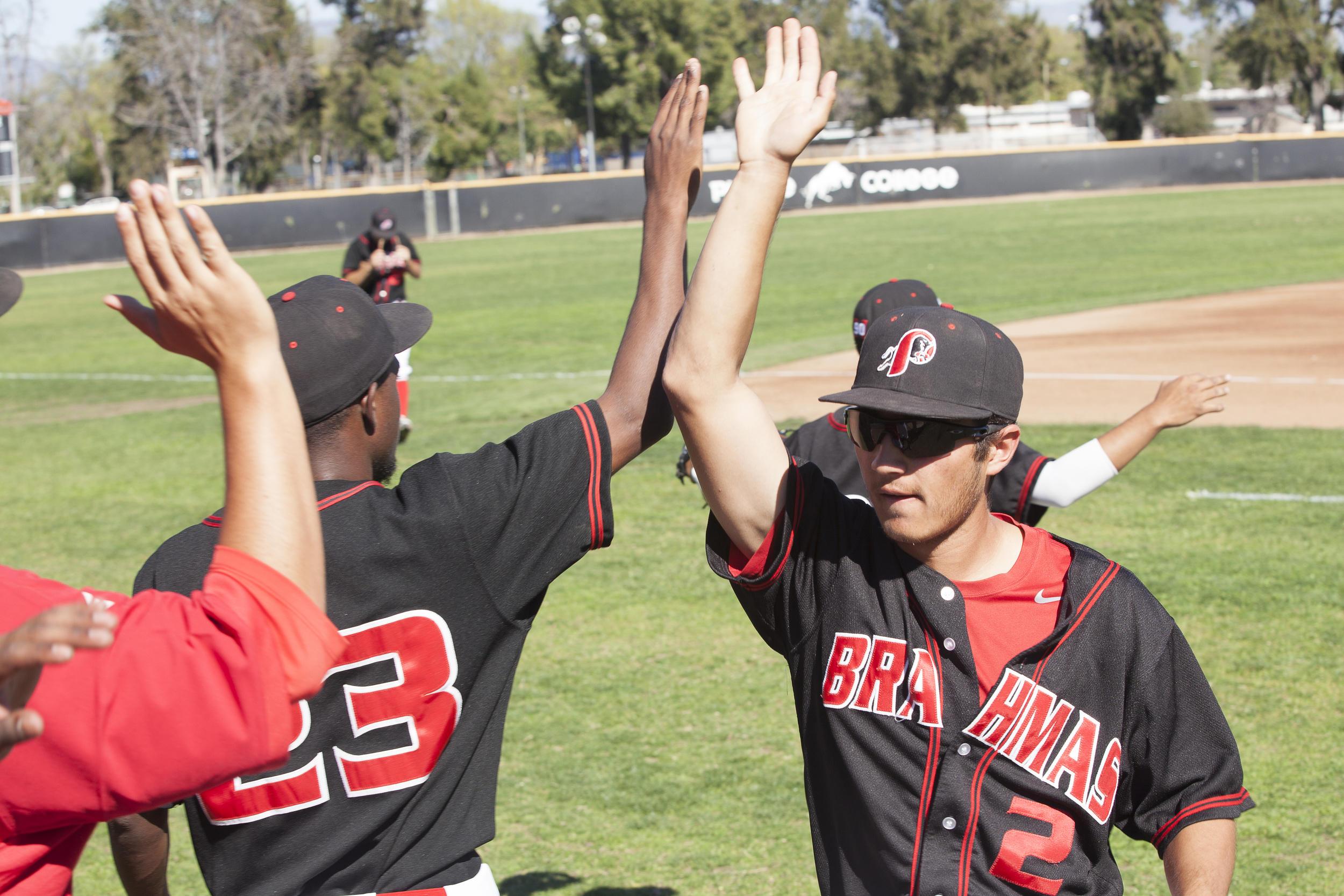  Jordan Abushahla, right, receives high fives from teammates as he walks to the dugout after the top of the first inning in a home game against Glendale College in Woodland Hills, Calif. on Saturday, Feb. 13, 2016.&nbsp; 