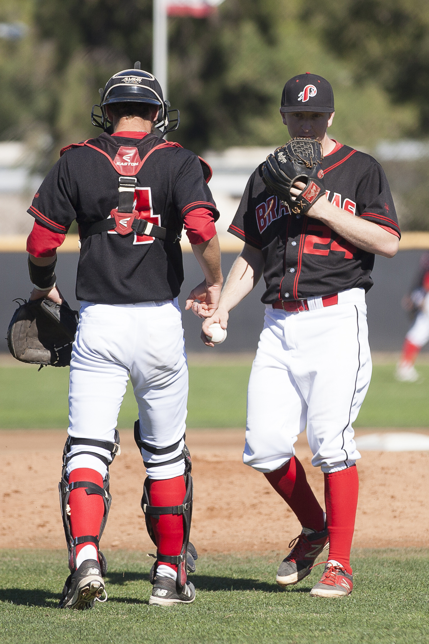  Evan Yeager, left, has a brief meeting with Brett Weisberg on the mound before facing the next Glendale batter during a home game in Woodland Hills, Calif., against Glendale College on Saturday, Feb. 13, 2016. 