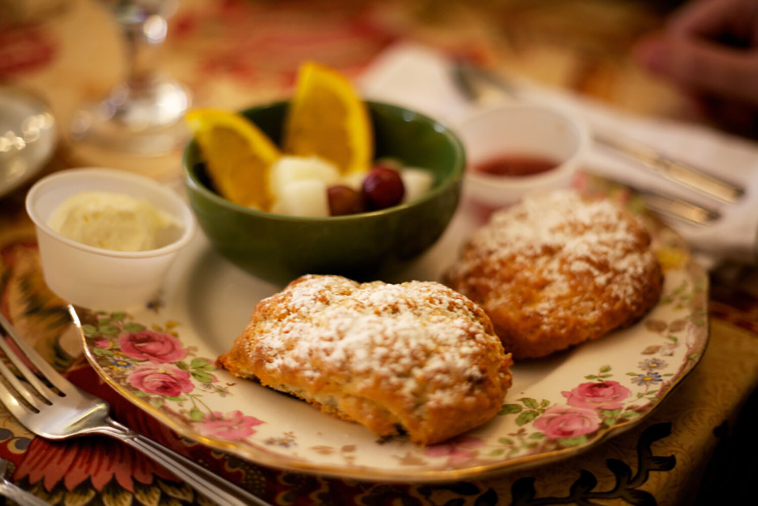  Delicious scones topped with powdered sugar and served with cream and jam! 