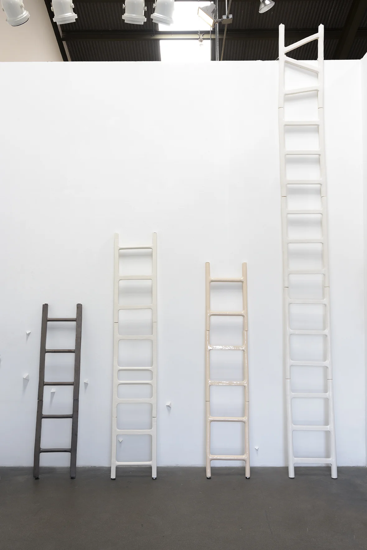 Elizabeth Orleans (Glazed ceramic ladders: Left to Right) Proceed , 2016: 58 x14 x2 inches Elevate , 2016: 82.5 x 15 x 1.5 inches Peach Progression , 2016: 72 x 14.5 x 1.5 inches Escape , 2016: 158 x 15.75 x 1.75 inches