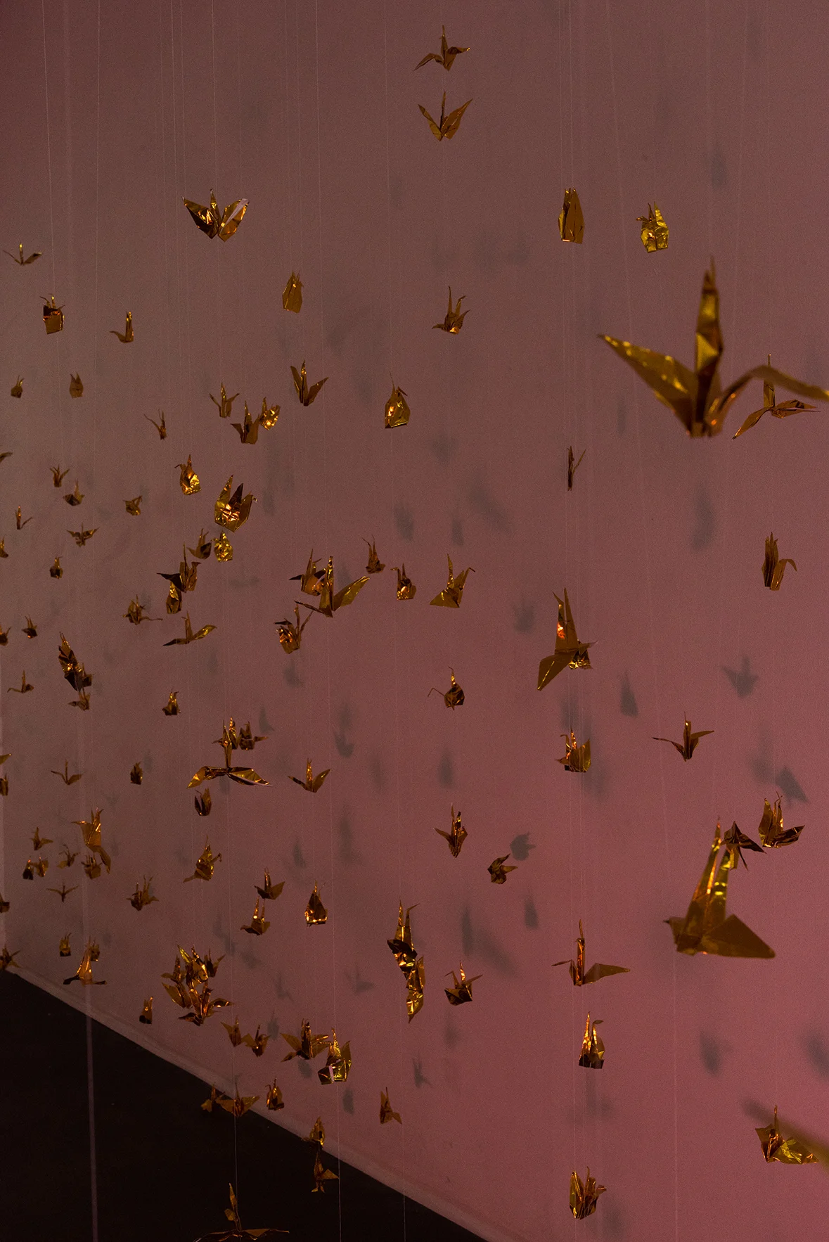 Isabelle Harada W=Fd , 2016 Variable dimensions 999 foil origami cranes, thread, mylar gels