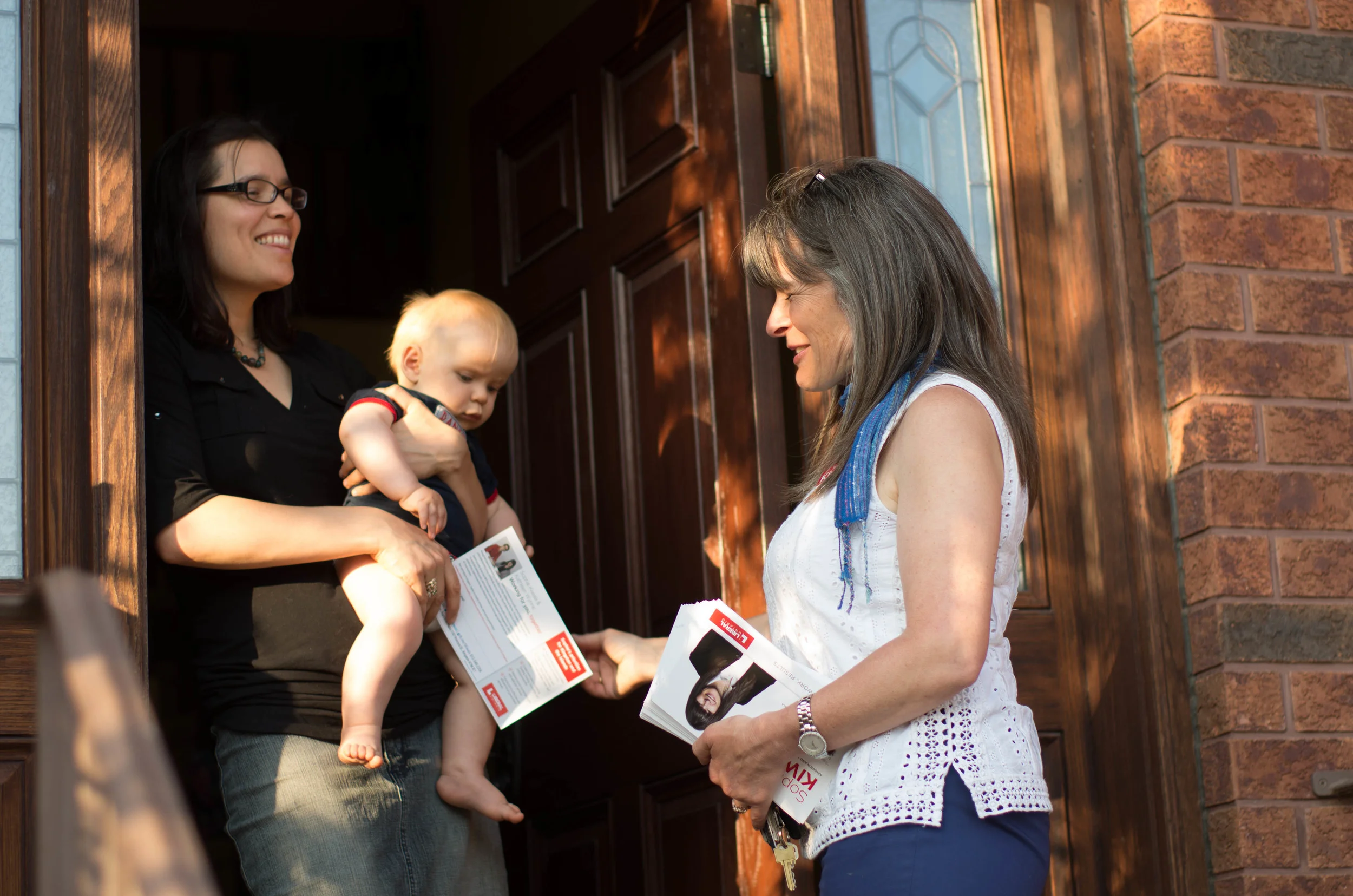Sophie Kiwala, the Liberal candidate and eventual member of provincial Parliament representing Kingston & the Islands, canvasses door-to-door with her campaign team in Kingston's Sydenham District. "Candidates talk student issues" (Queen's Journal )