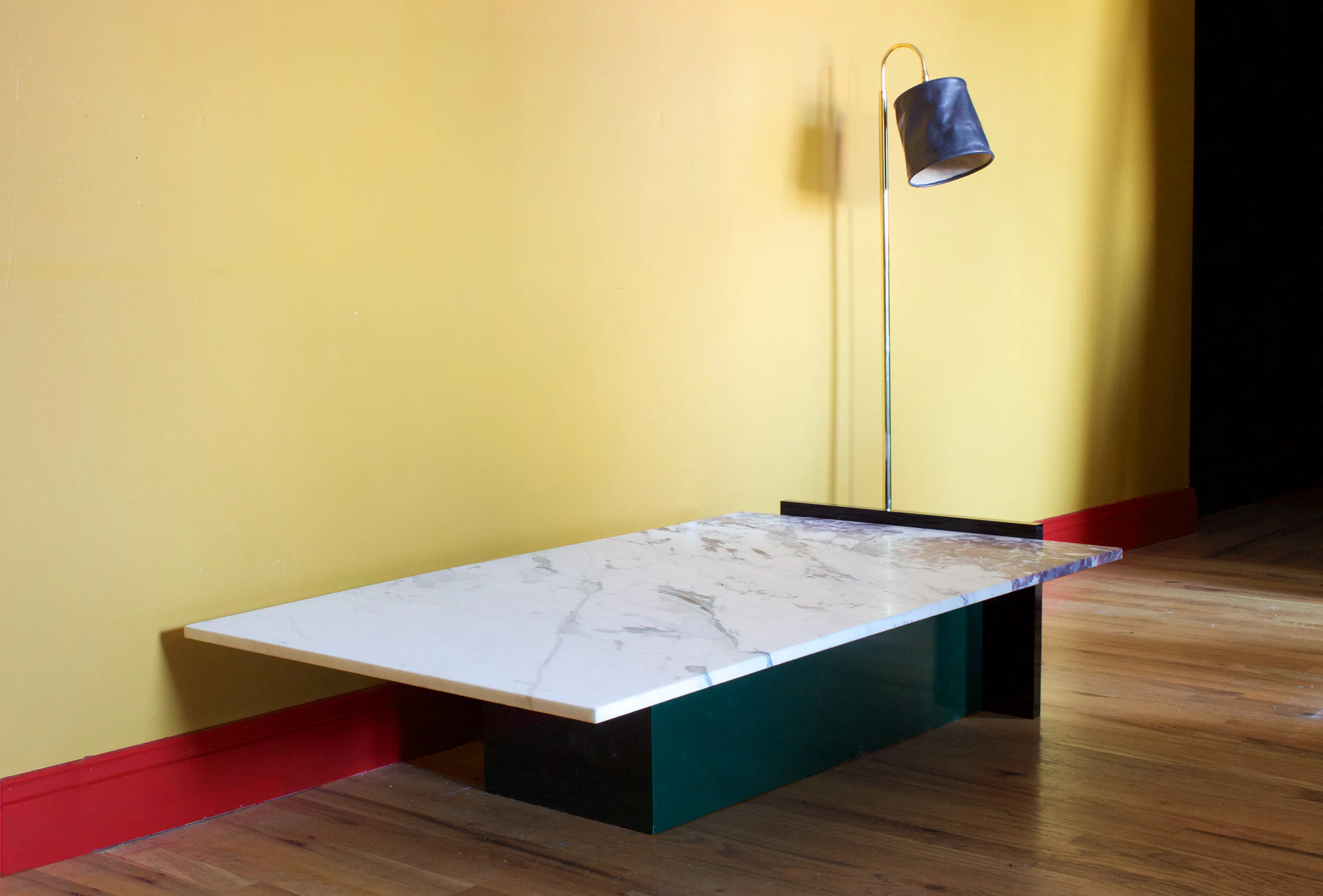 Coffee table in Paonazzo marble, black polished acrylic and high gloss oil on wood; Series 01 floor lamp in charcoal leather, 2015.