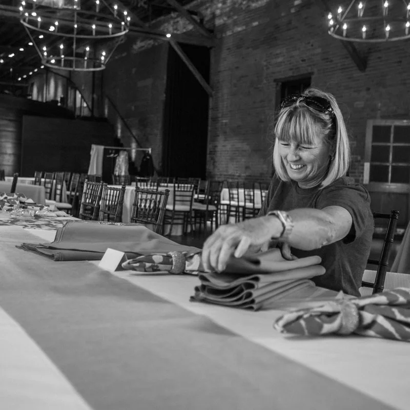 Peggy-folding-napkins-bw-1x1.jpg