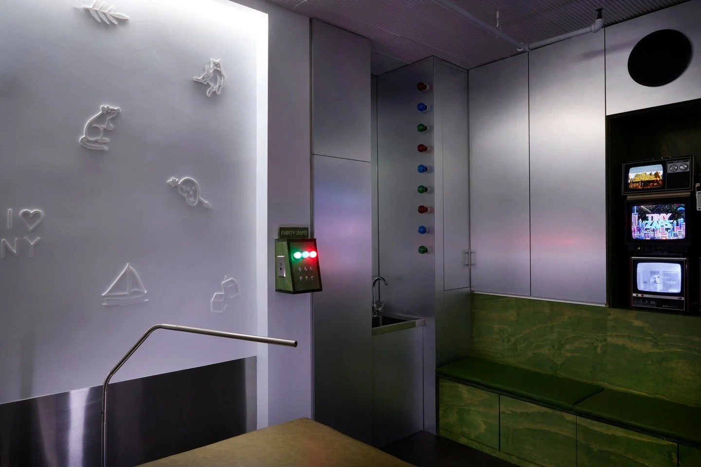 In a green monochromatic immersive space like Tiny Zaps, we wanted to design a visual break from the green green green.  So in the rear of the space we designed the Party Zaps room where the color of the space depends on the whim of the customer.  An