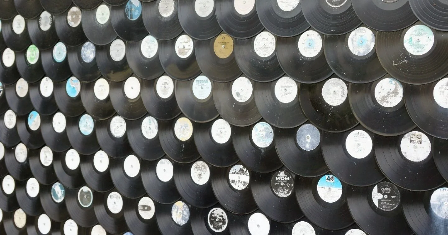 A detail of a custom black vinyl wall covering designed for a workplace interior. Graphic and tactile, it transforms a functional surface into a refined moment of material expression.