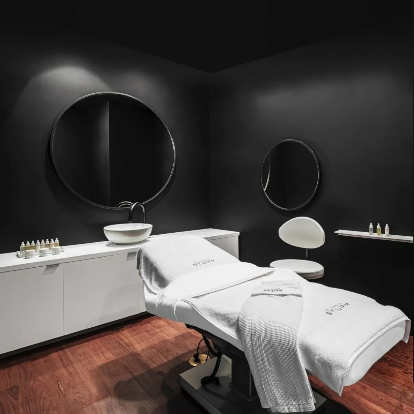 For Dr. Barbara Sturm&rsquo;s Miami Design District boutique and spa, we designed the treatment rooms as quiet, immersive retreats. A dark, subdued palette and low lighting create a calming atmosphere that supports a deeply restorative wellness exper