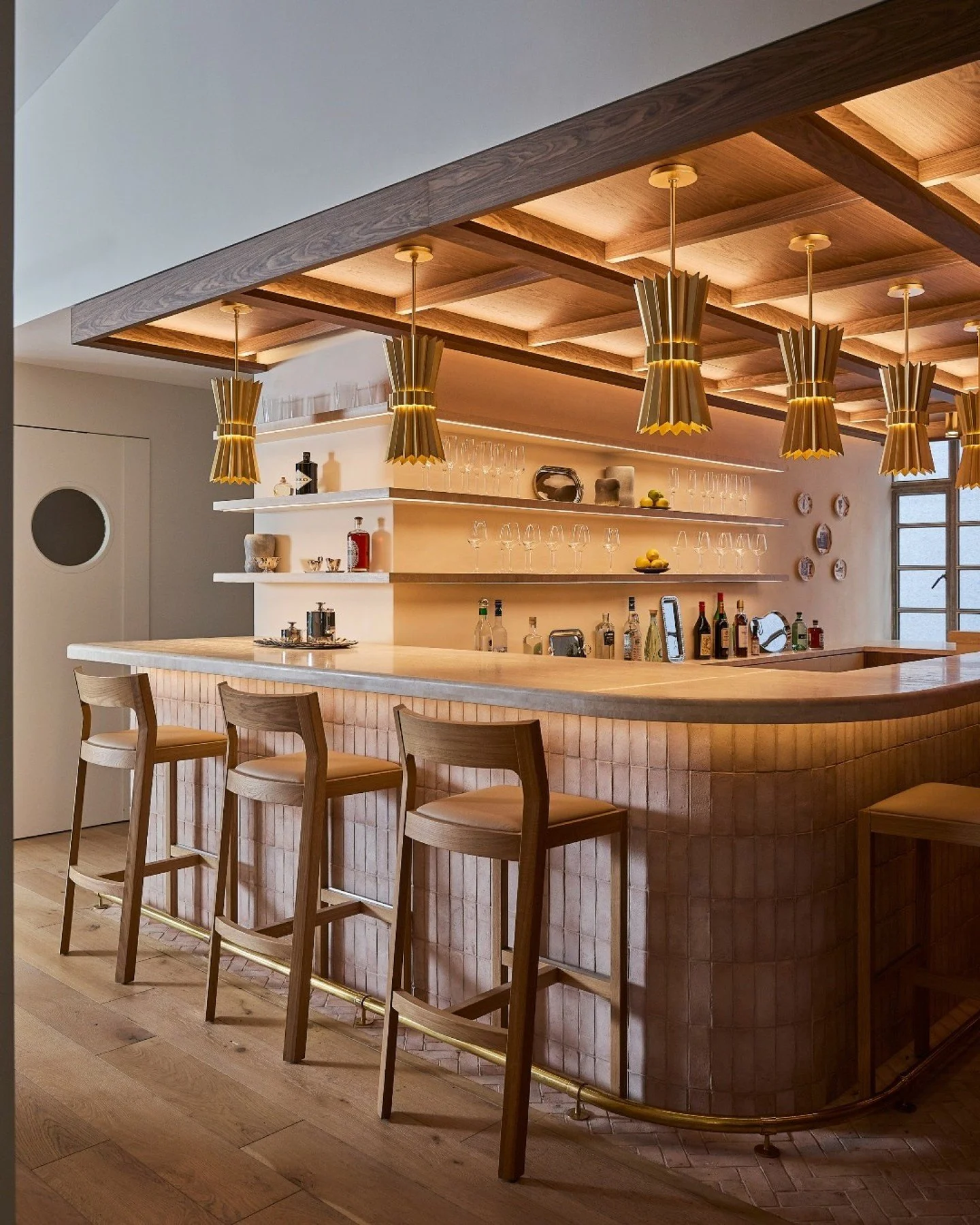 Here's a custom bar we designed for the SmartFlyer Penthouse, bringing layered materiality to life. A honed travertine bar top anchors the space, complemented by floating travertine shelves with integrated LED lighting that cast a soft, ambient glow.