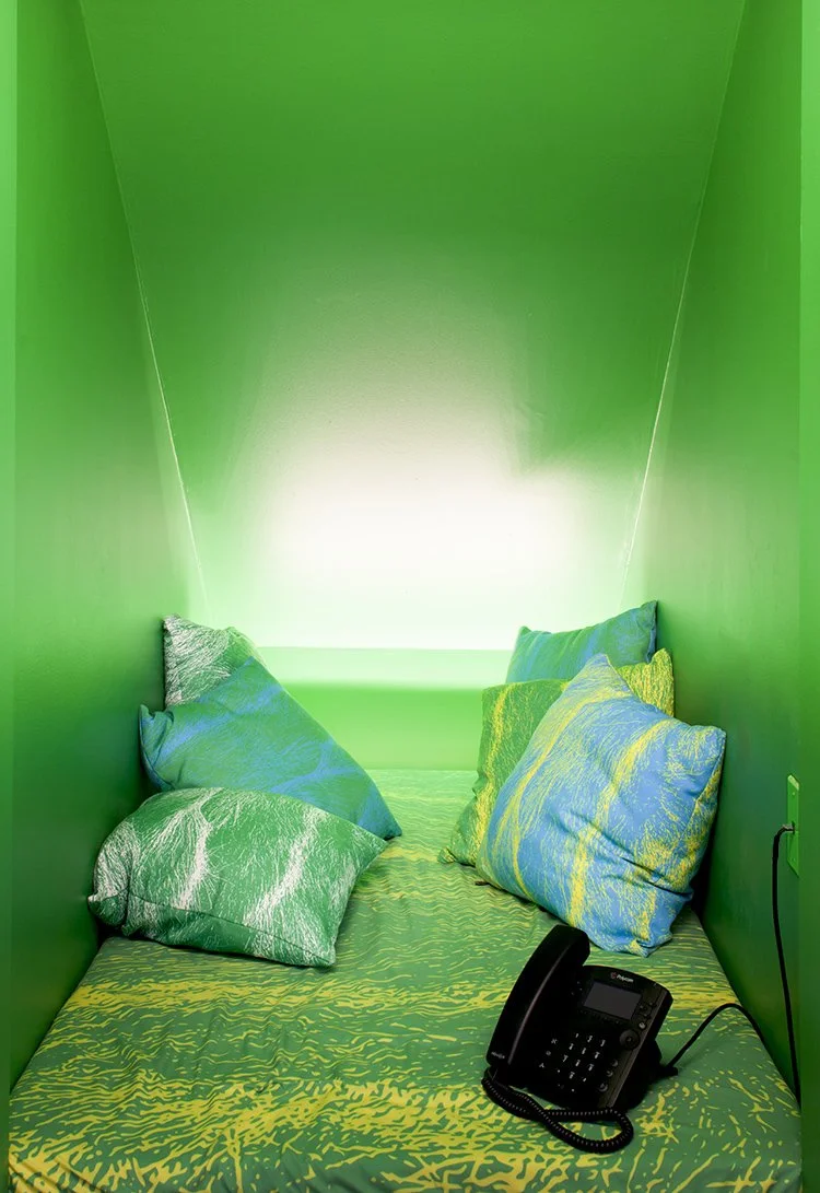 Green room with pillows and telephone