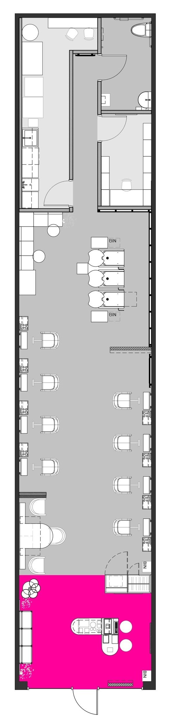 Floor plan of a commercial space with seating and work stations, a restroom, kitchen area, and entryway marked in pink.