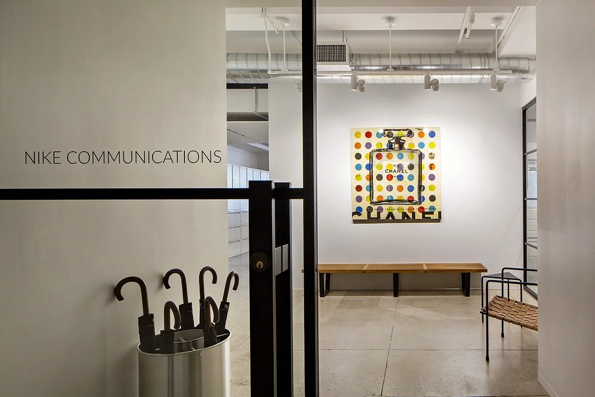 Interior of Nike Communications office with a modern art piece and umbrella stand