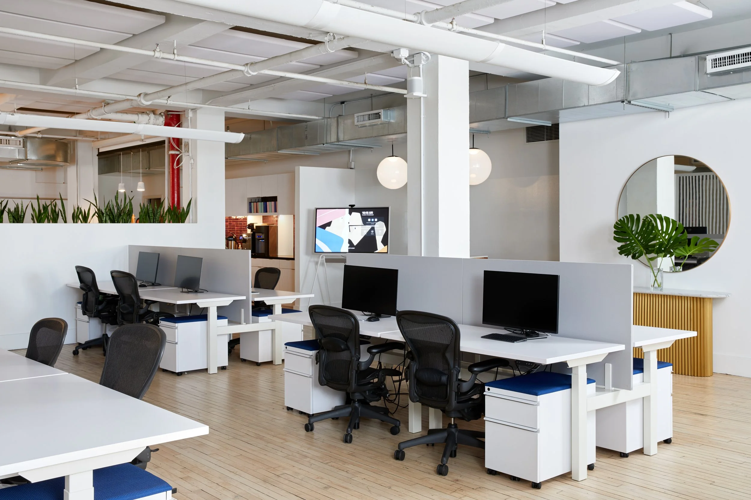 Modern office space with desks, chairs, and computers