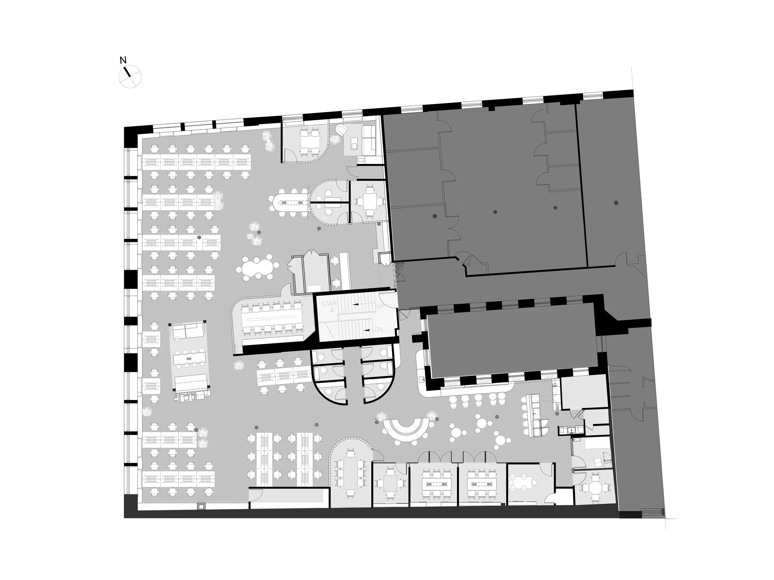 Architectural floor plan of an office layout with workstations, meeting rooms, and communal areas.