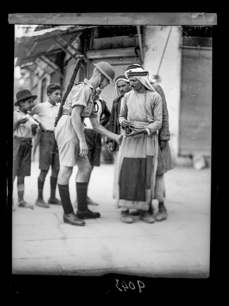  A British soldier searches a Palestinian citizen. 1936