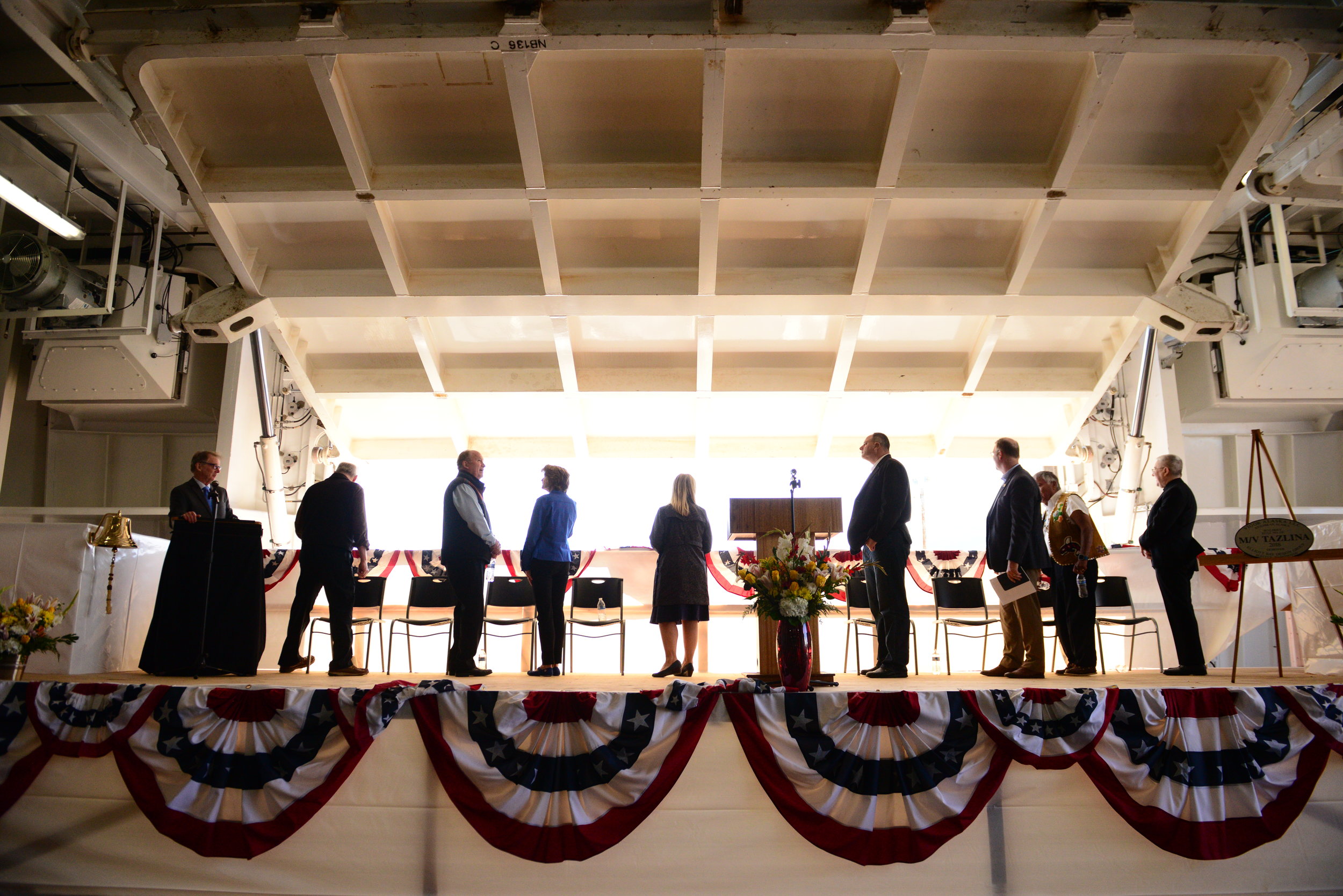  Representatives including Gov. Bill Walker, First Lady Donna Walker, Senator Bert Stedman, and Senator Lisa Murkowski are silhouetted as the rear loading dock of the Alaska Marine Highway’s newest vessel, the M/V Tazlina, is opened to the sun during
