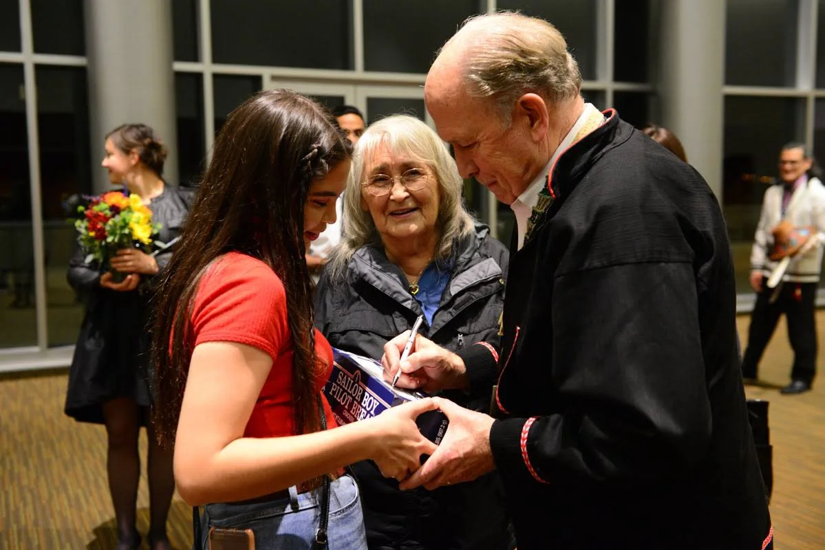 Governor Walker signs a box of Pilot Bread at the 2018 Smokehouse Gala in Anchorage. November 18, 2018.