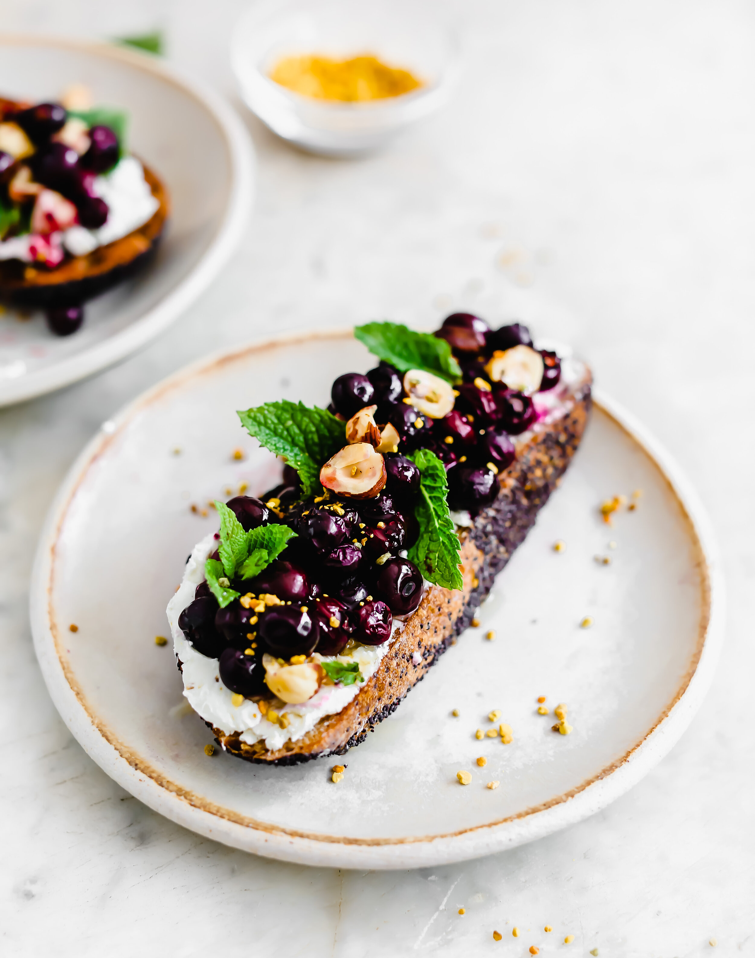 Oven Roasted Blueberries and Honeyed-Hazelnut Clusters over Goat Cheese Toast