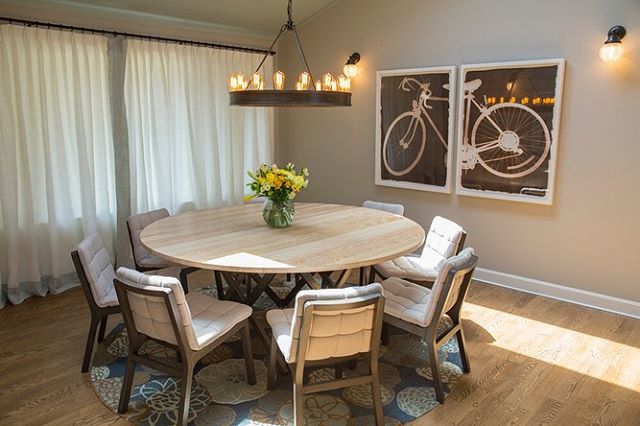 Circles prevail in our design solution for our client&rsquo;s dining room. The combination of a Ralph Lauren chandelier, a round table, curves in the area rug, and wheels in the art keep the dining room playful and casual. The dining chairs feature r