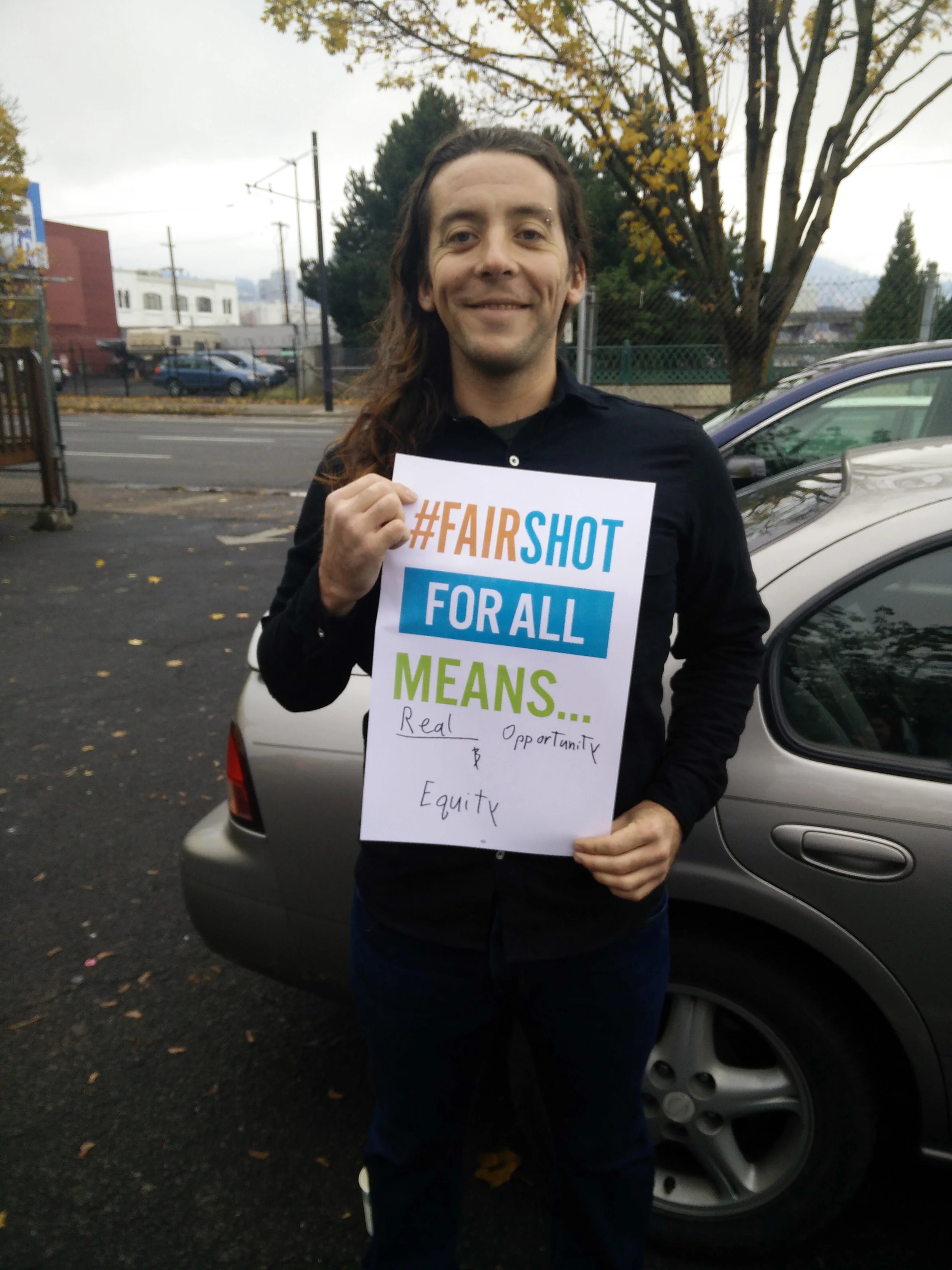 Impact NW and YWCA intern Alex at the Fair Shot for All 2016 Agenda Launch. 