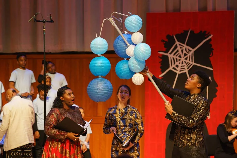 Anansi and his daughters Esi and Afia marvel at the beauty of the light they found.