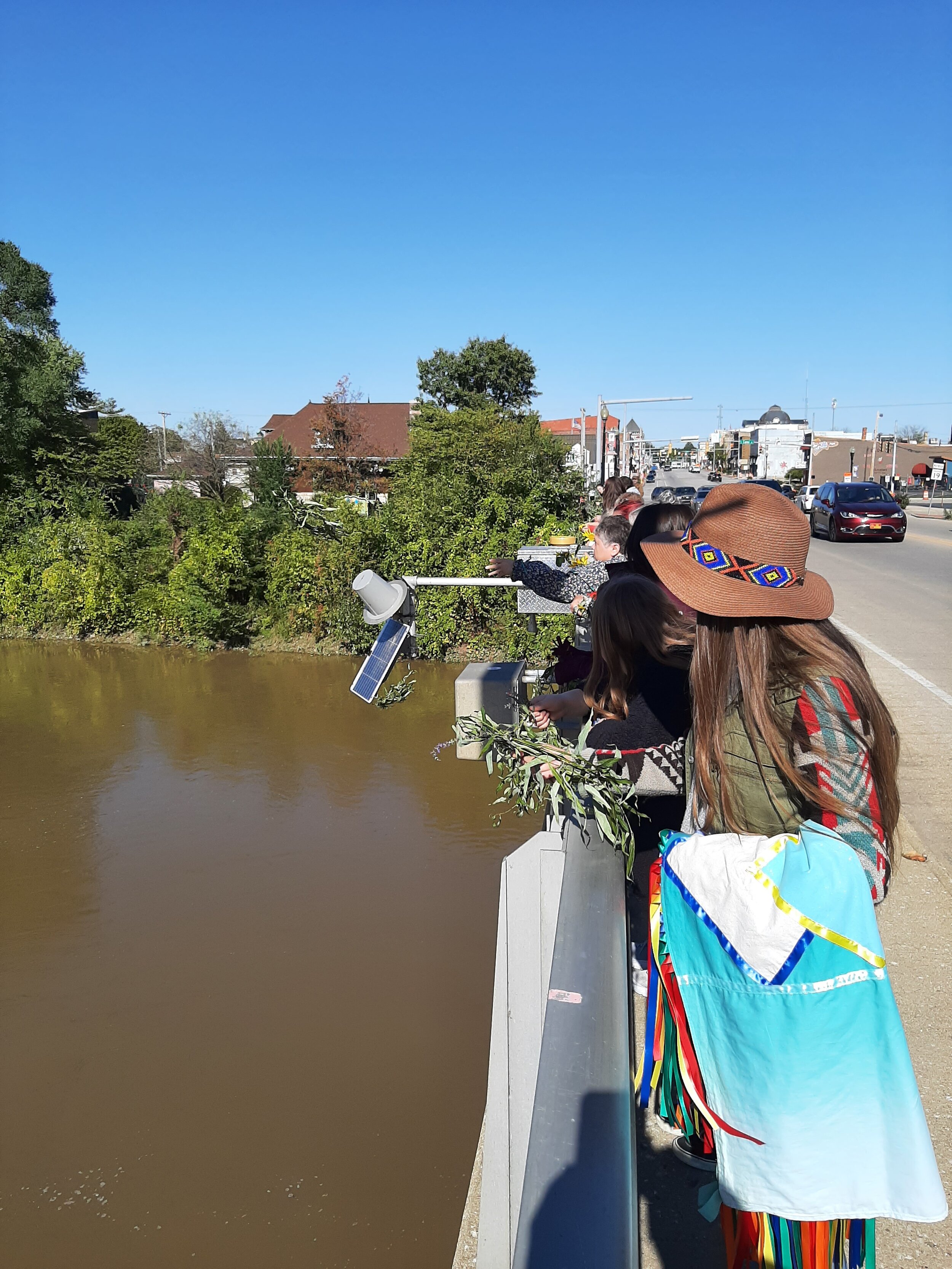 Ladies on Bridge waiting to drop Wreaths into the river.jpg