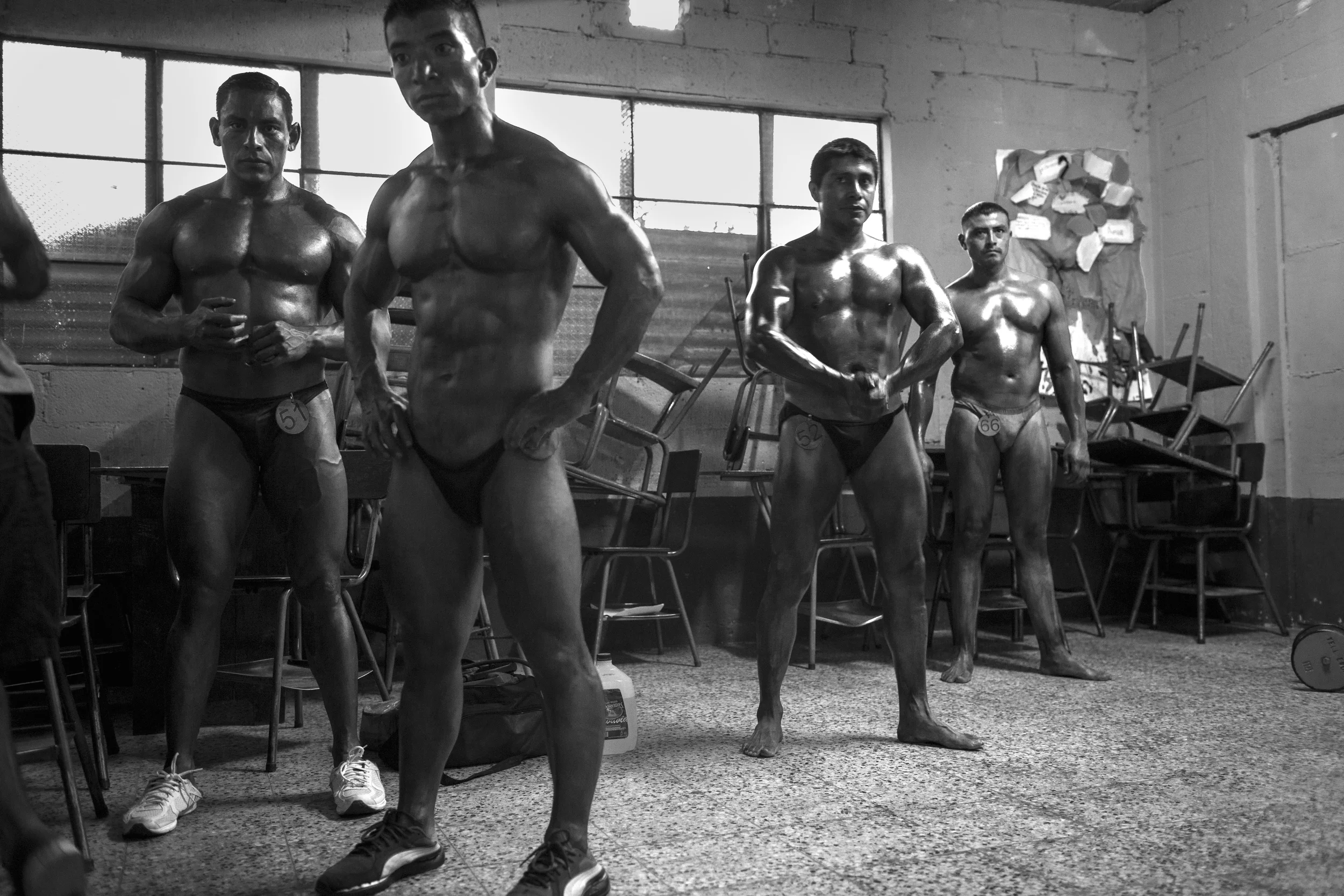  A classroom is converted into a prep room at the Gimnasio La Fábrica bodybuilding contest in Antigua, Guatemala on July 19, 2014. 
