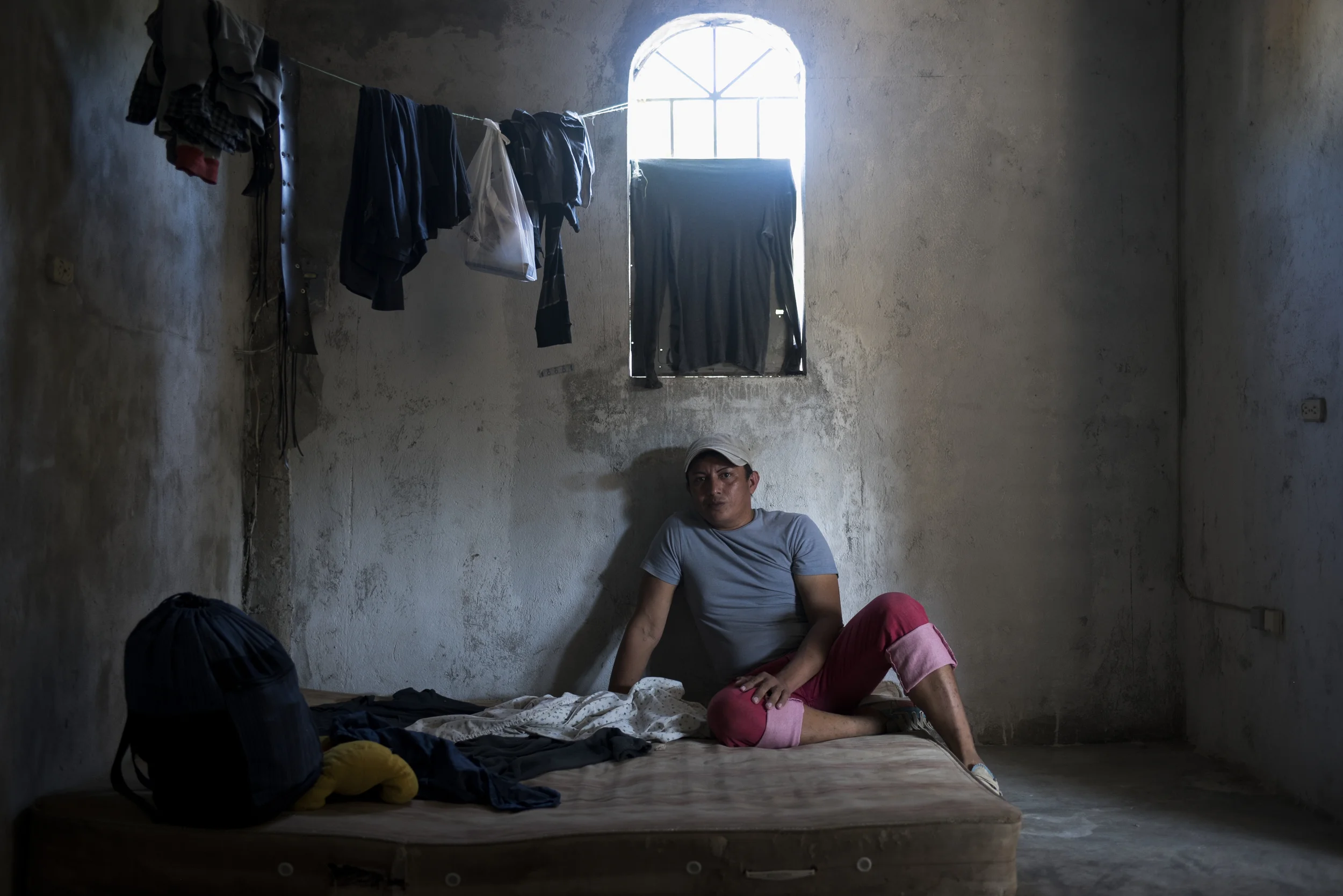  TAPACHULA, MEXICO - January 8: Danielo Munguia, 34, from El Salvador,  in the one room house he shares with three other people on January 8, 2016 in Tapachula, Mexico. Danielo is transgendered but had all of his clothing robbed while staying at a sh