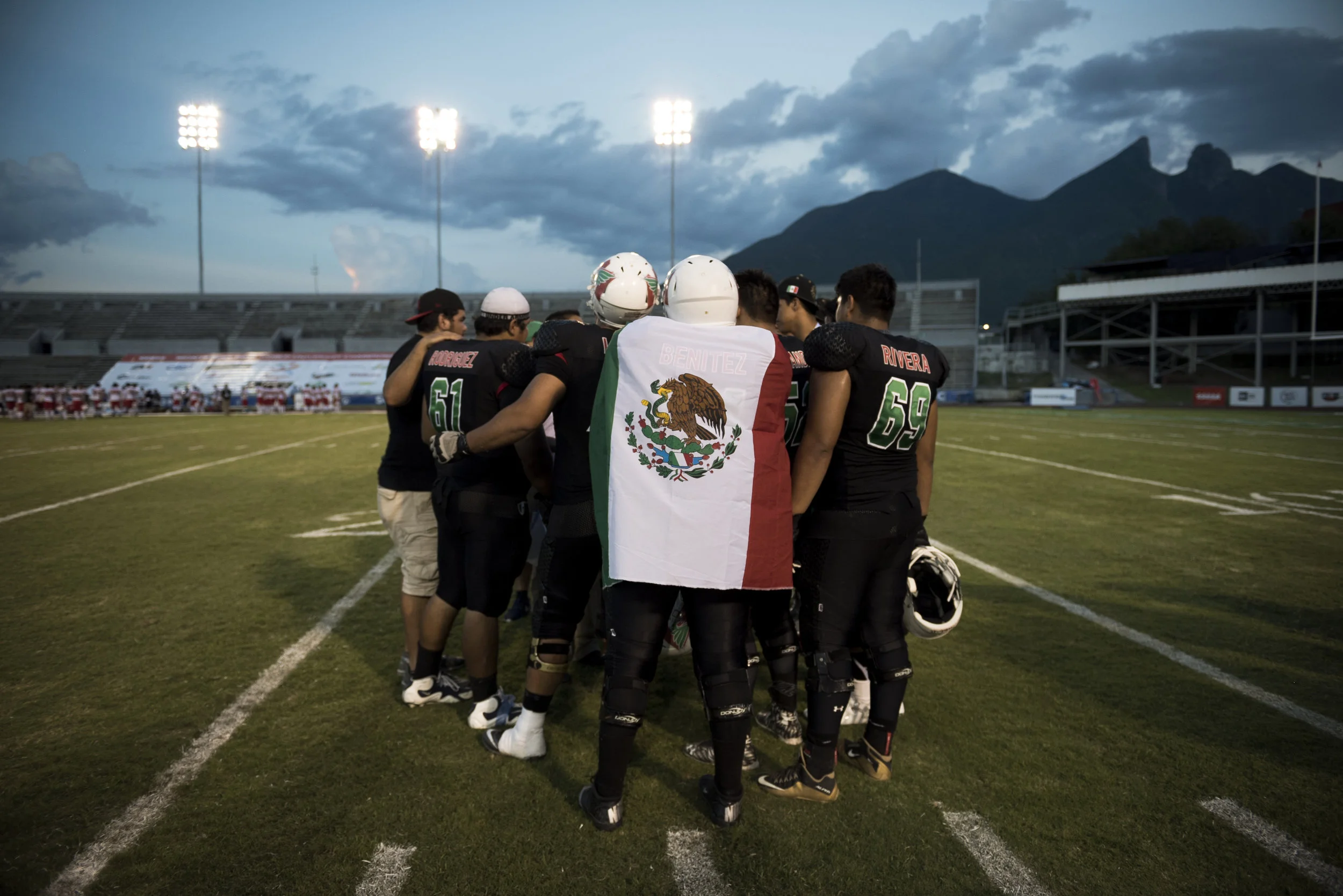  MONTERREY, MEXICO - JUNE 8, 2016: Offensive lineman Omar Edgar Benitez Palma drapes himself in the Mexican flag after his team's 36-3 victory over Japan at the 2016 American Football World University Championship on June 08, 2016 in Monterrey, Mexic