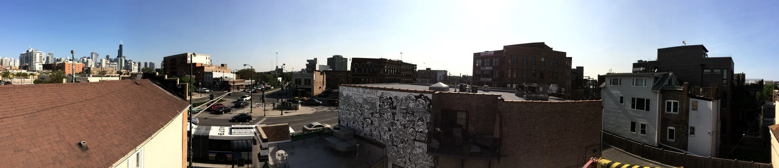 A PANORAMIC VIEW. YOU CAN SEE THE SEARS TOWER TO THE LEFT AND THE MURAL IN THE MIDDLE OF THIS SHOT.