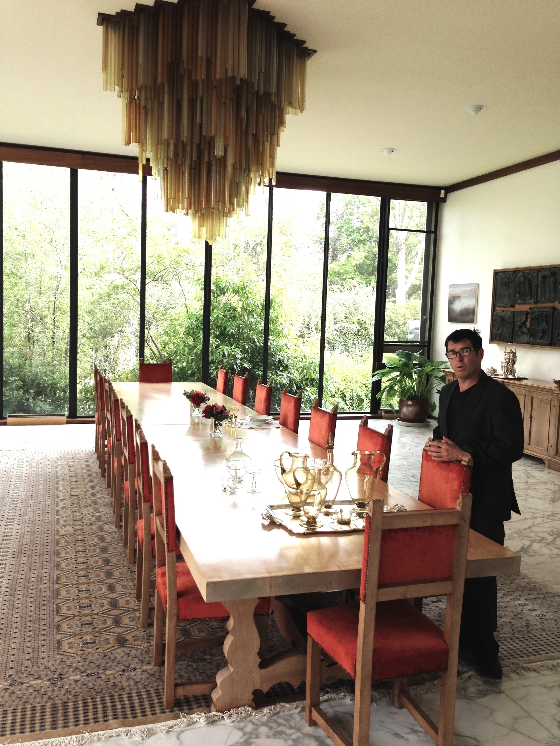  Participating artist Ben Edols&nbsp;in the Italian Ambassador's residence, Canberra,&nbsp; inspecting the fine amber Venetian glass tableware and chandelier. 