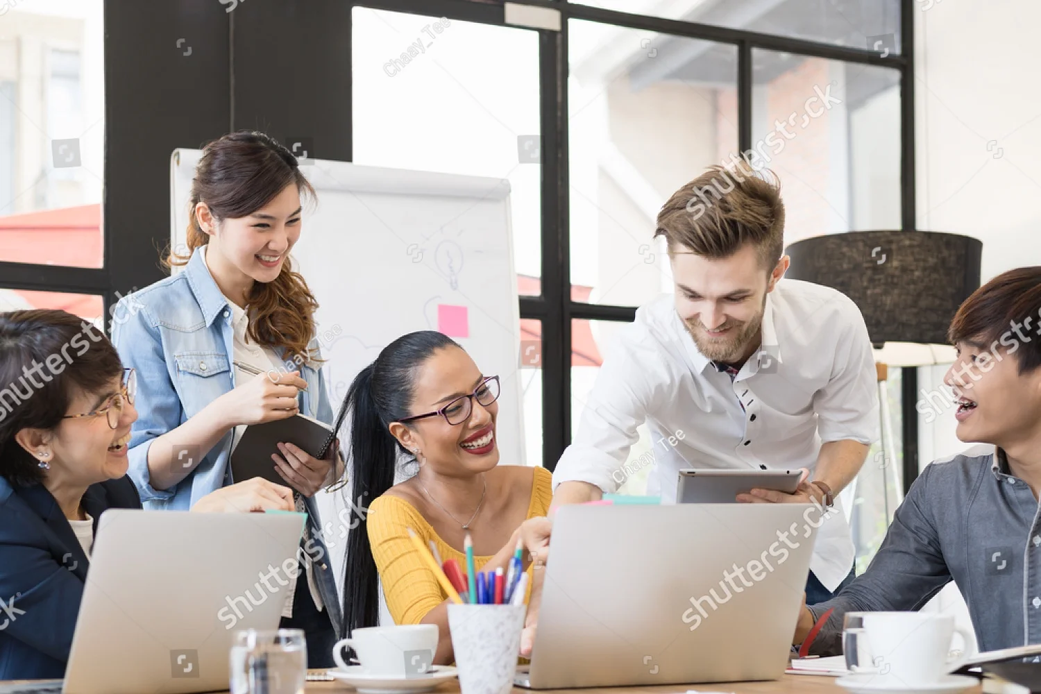stock-photo-multiethnic-group-of-happy-business-people-working-together-meeting-and-brainstorming-in-office-598400243.jpg