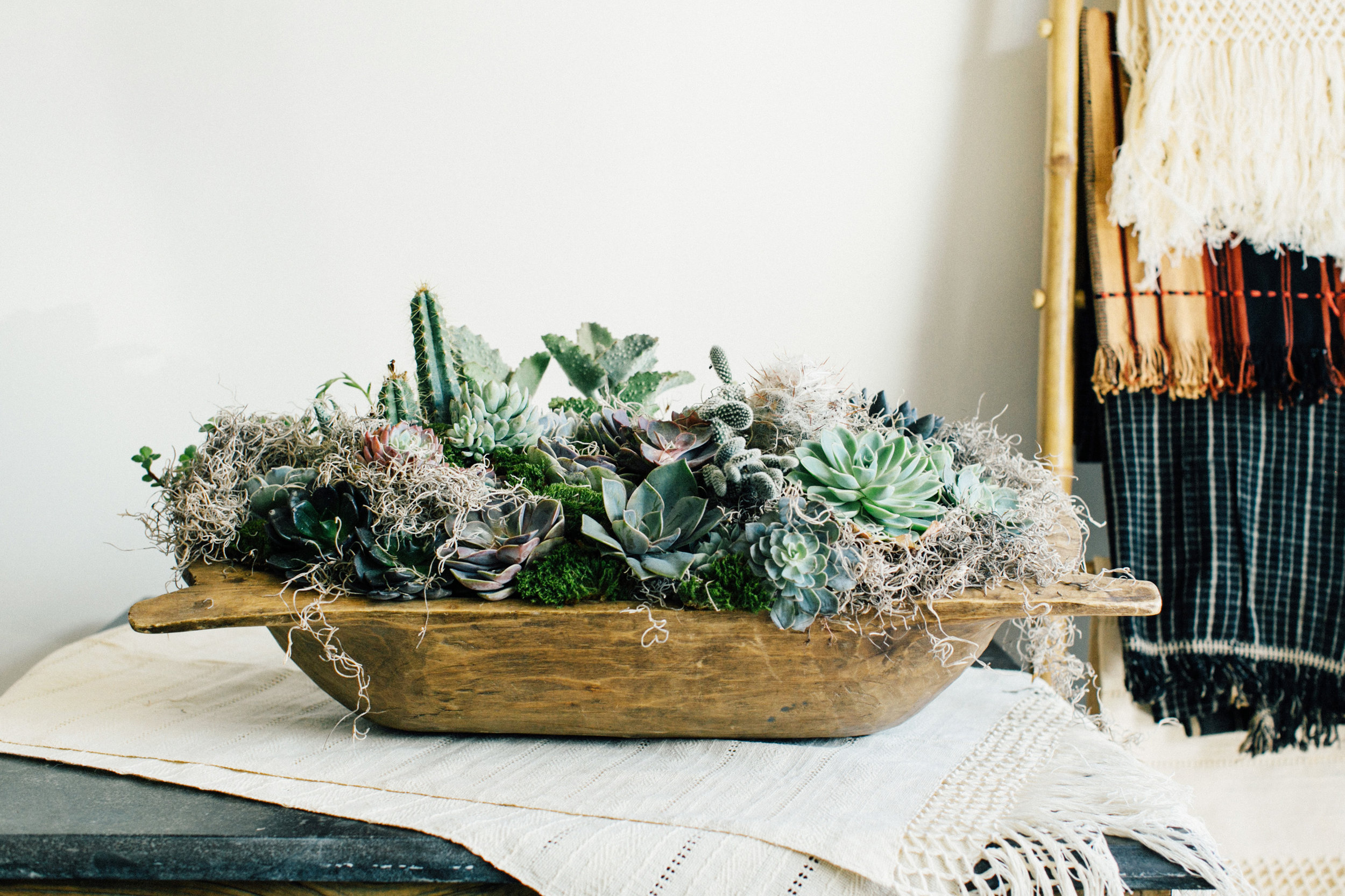 Here are some faux pieces mixed with real, and we love seeing them in one of Pottery Barn's dough bowls from years past. Arrangement | Colonial House of Flowers