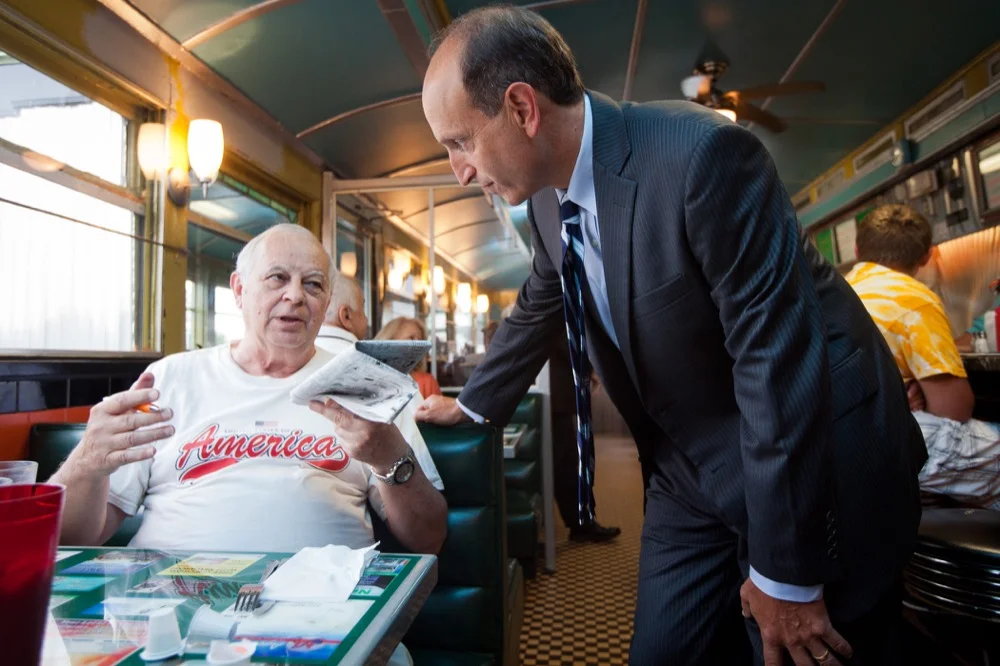 Saturday, July 13, 2013 - Dan Wolf talks to patrons at the Owl Diner in Lowell prior to the launch of his campaign for Governor of Massachusetts at the state democratic party platform convention. (© 2013 Eric Haynes)
