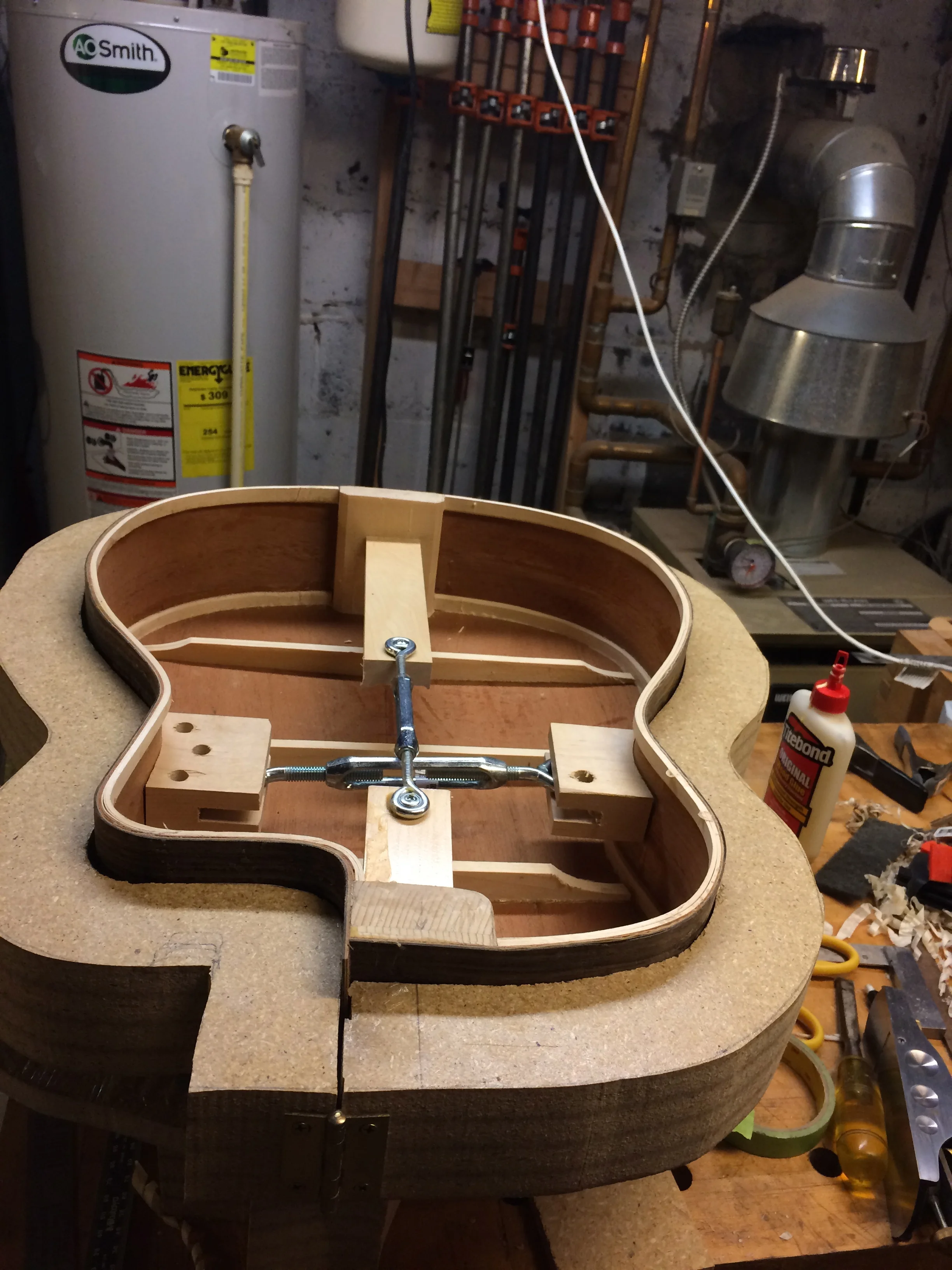 Here is the glued up back and sides in the form with the curved braces glued on the back. The linings are laminates as well.