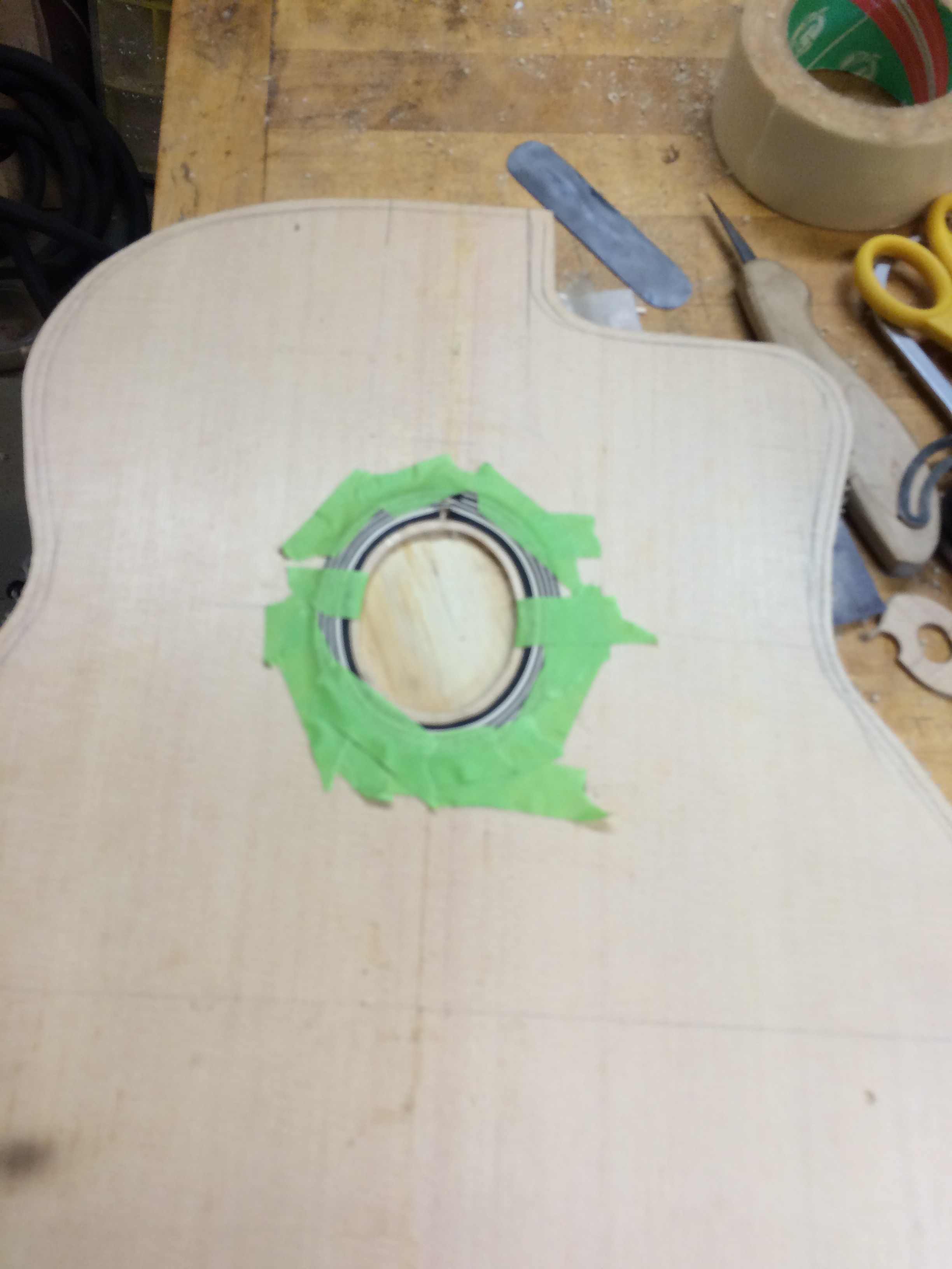 I put the purling in strip by strip and then flooded the inlay with thin super glue. Once it was dry I cut the tips where they met in a haphazard way and inlayed an ebony "key." 