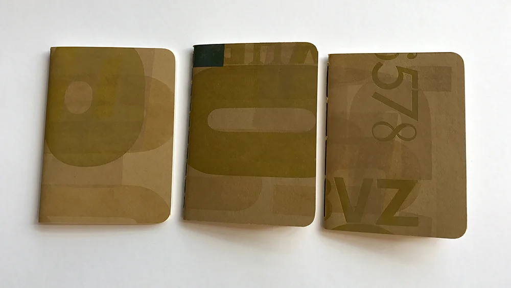 Pamphlet-bound notebooks with covers letterpress-printed from wood type.