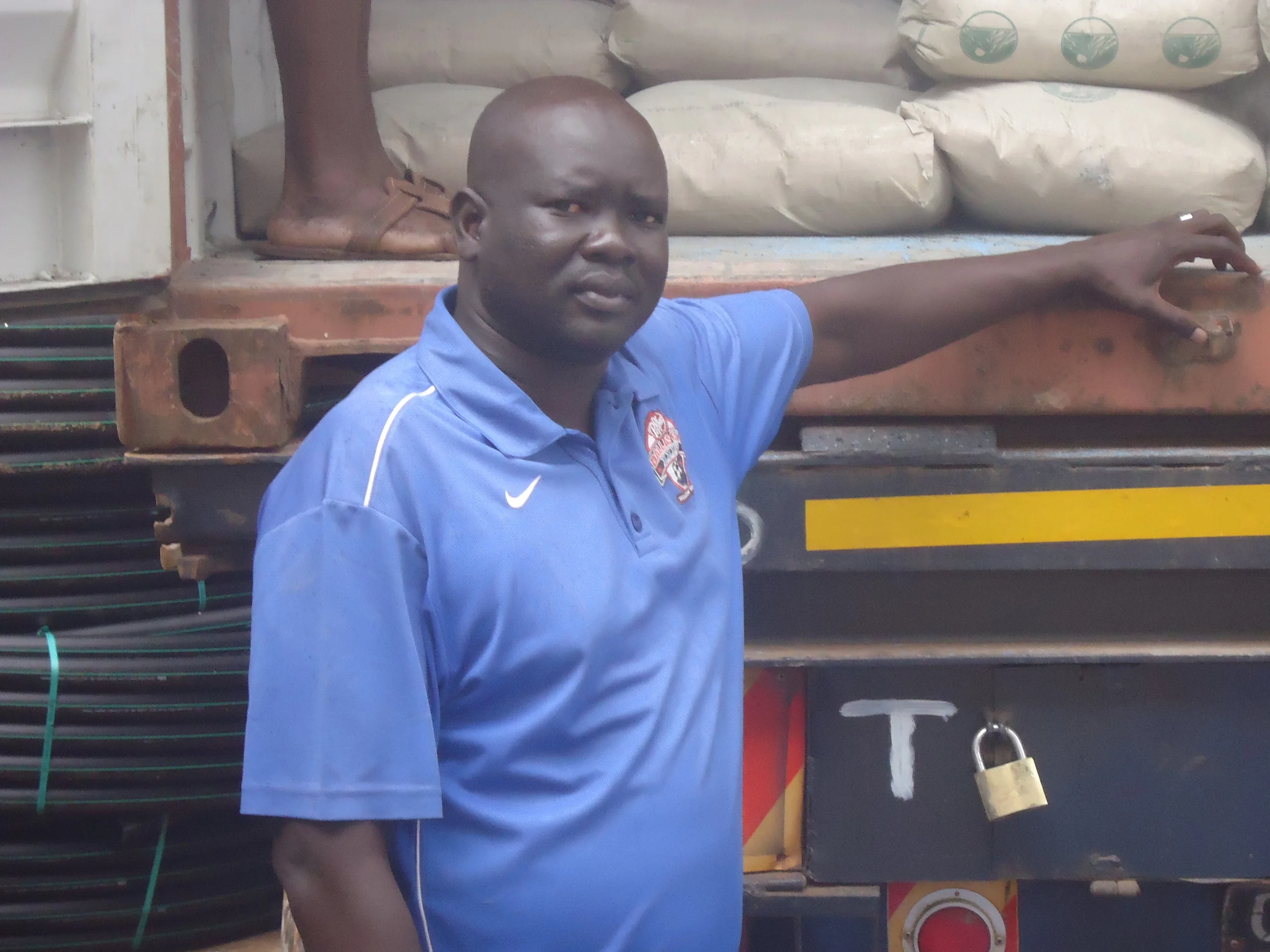 WFSS Field Operations Manager Ajang "AJ" Agok with supply truck in Kampala.