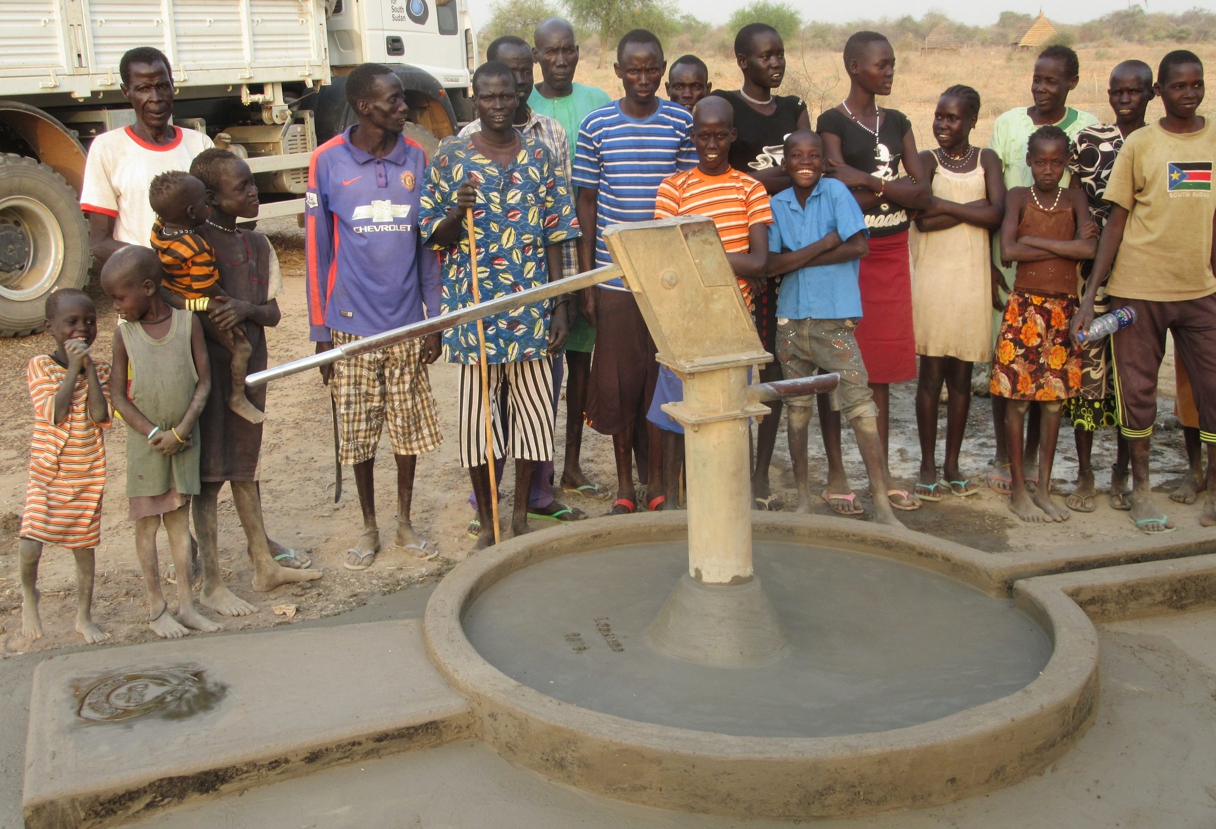villagers celebrate repaired well, ensuring a future with access to fresh water