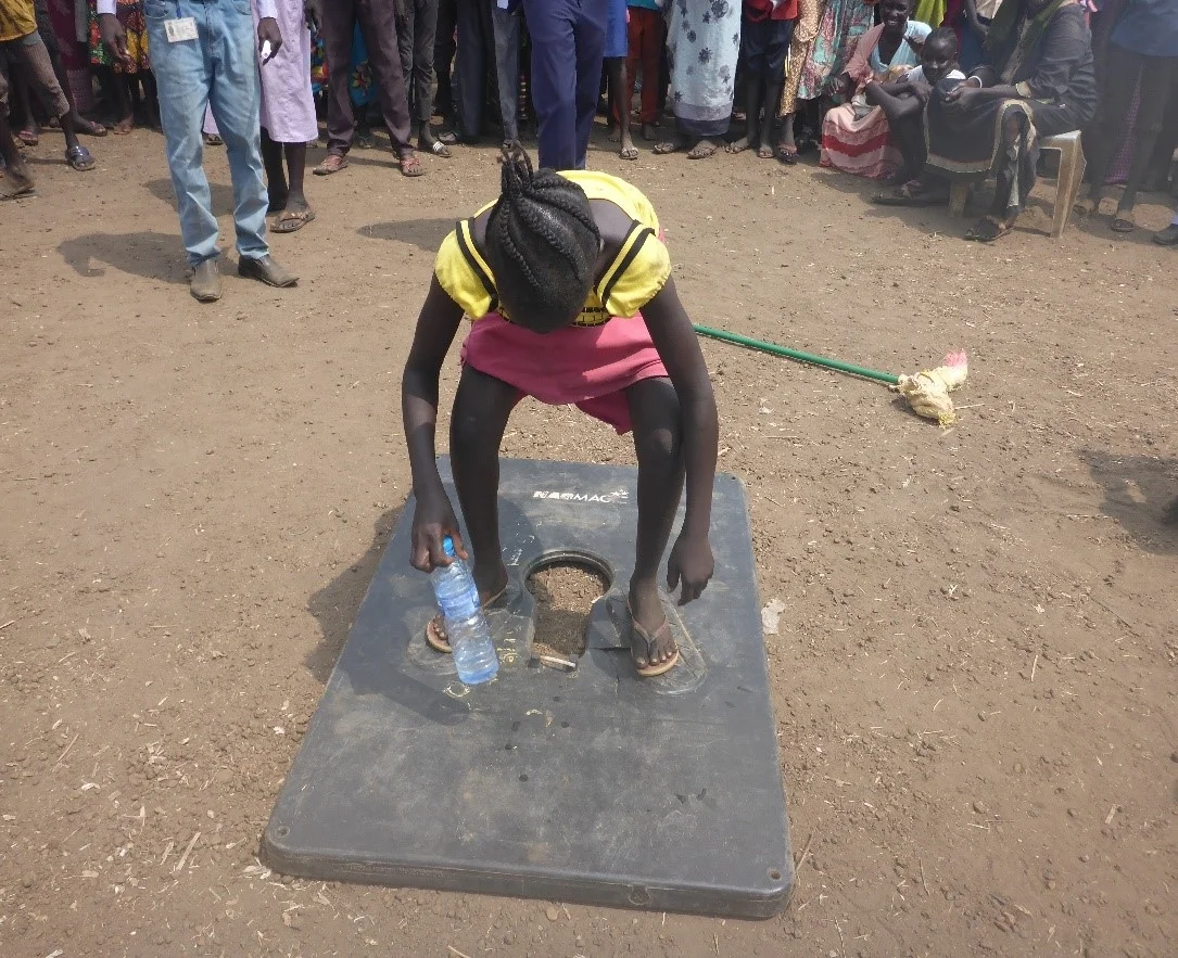 teaching children about sanitation practices in wau.