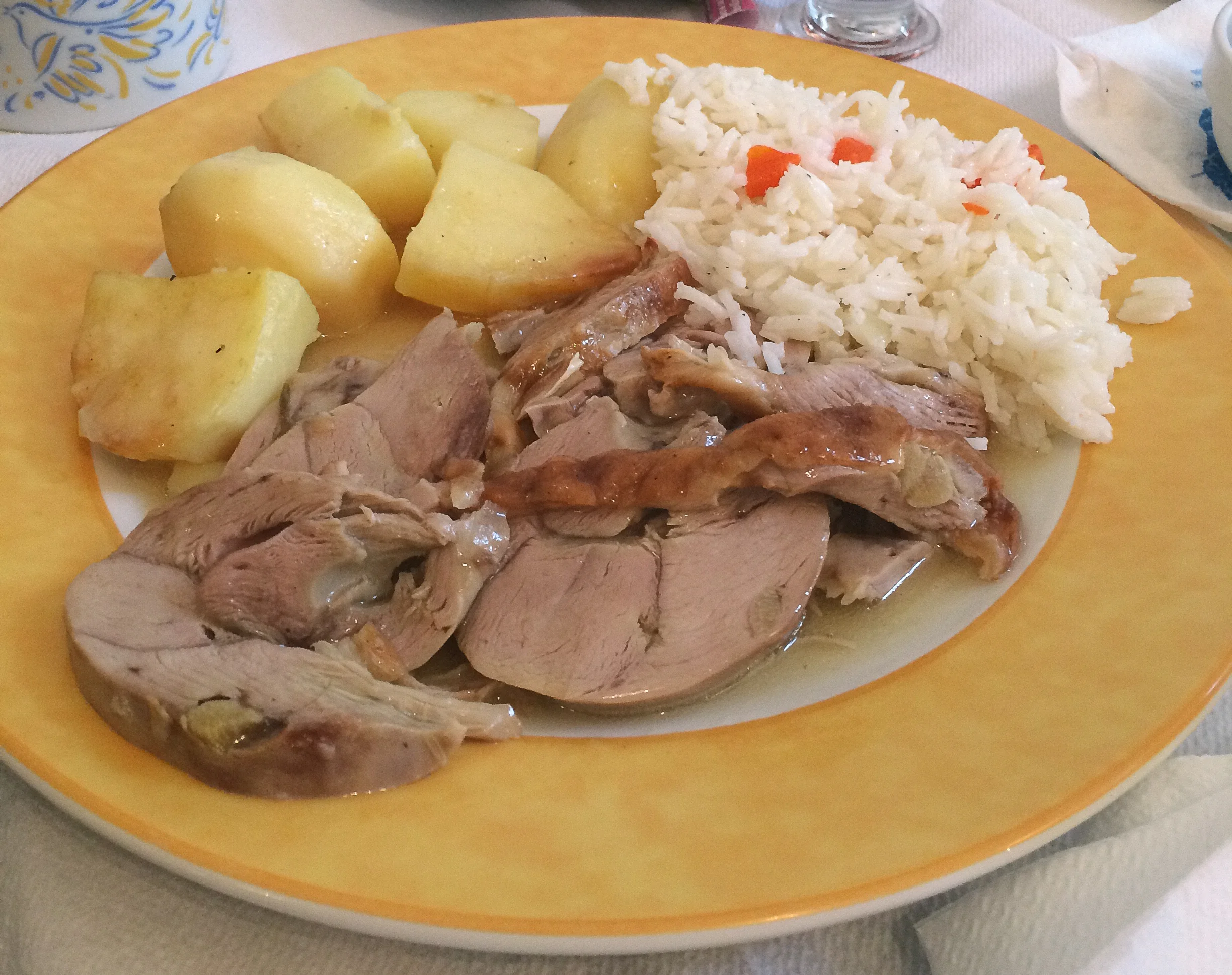 Traditional chicken souvalki with rice and potatoes.