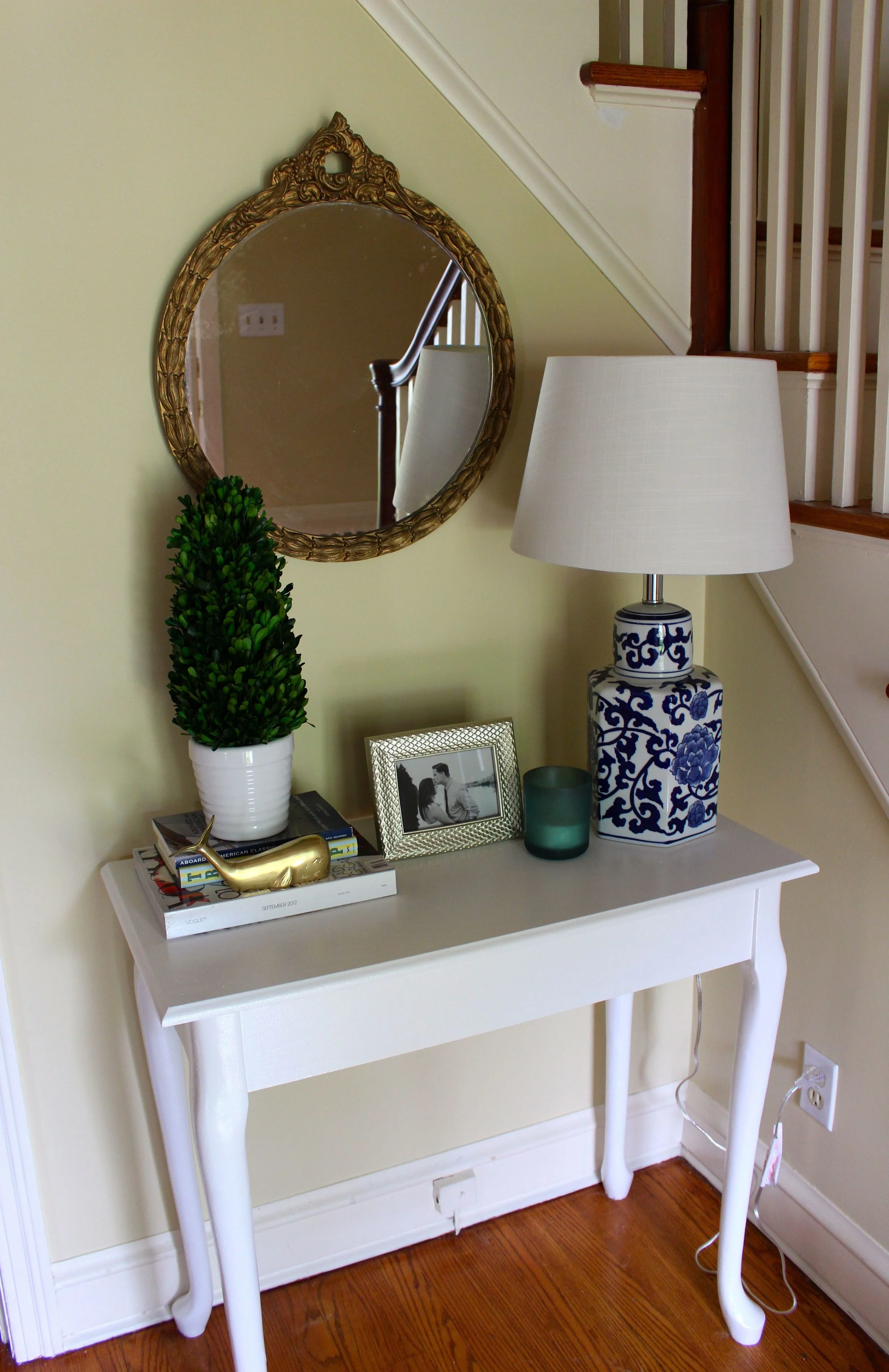 This table was Chris' grandma's old makeup table... we flipped the top around to cover mirror holes and painted it!