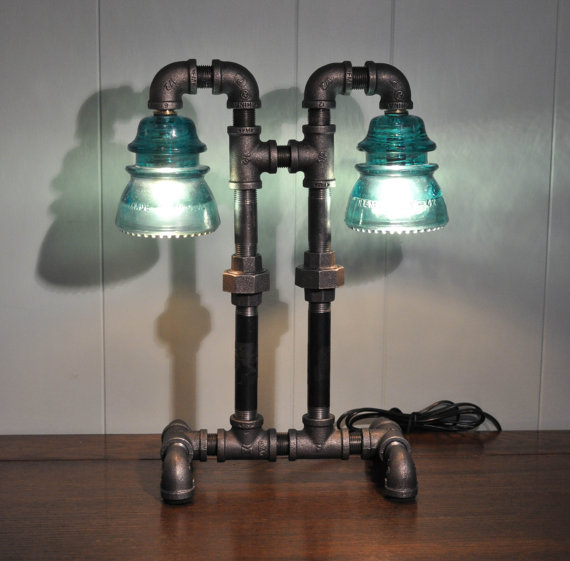 I am in love with these industrial lamps from the etsy shop luceantica . However, the price is not for everyone (including me). I did find a wall-sconce hack that can get you started over at Instructables . 