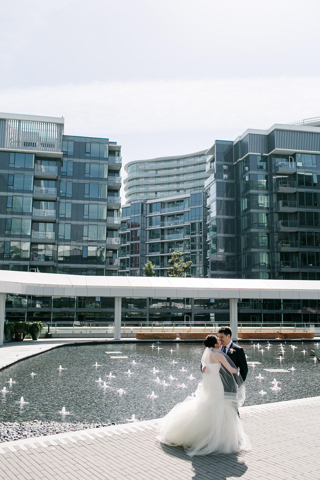 Jessica & Alex JW Marriott Parq Hotel Wedding in Vancouver. Bride and Groom portraits outside. Vera Wang wedding gown, Hugo Boss suit for the Groom | Keepsake Events