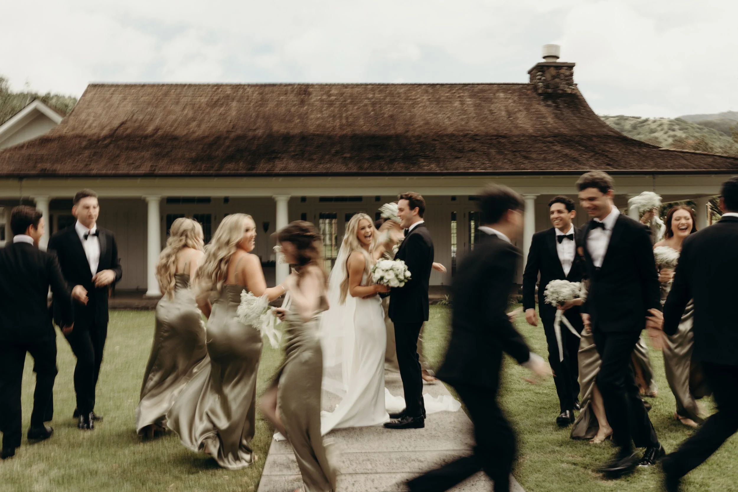 Bride and groom on their wedding day with their wedding party at Dillingham Ranch on Oahu's North Shore.
