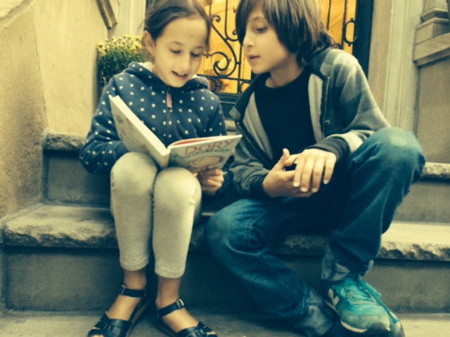 My daughter reading the book to her buddy on her grandmother's stoop the day we got our copy.