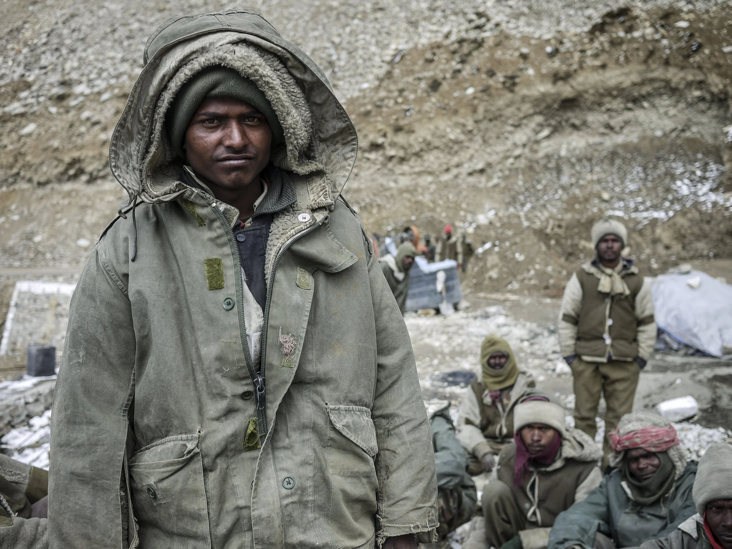 A young man wears several layers of clothing. Even in the middle of summer daytime temperatures can plummet at such high altitudes.